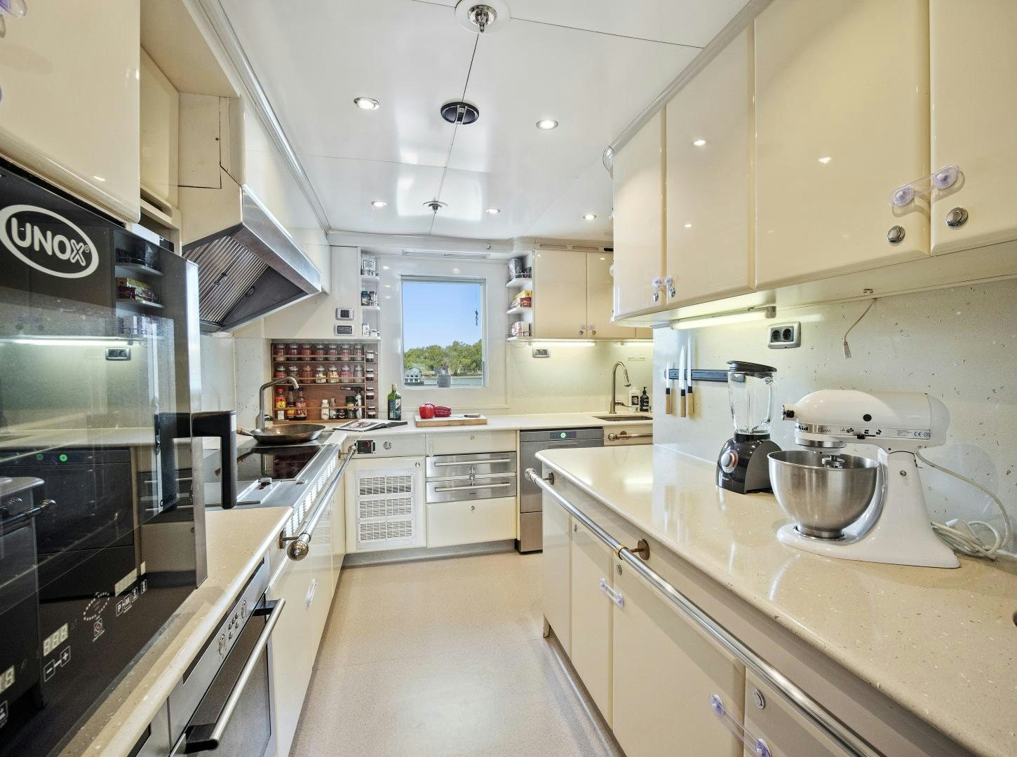 a kitchen with white cabinets aboard THE LANGLEY Yacht for Sale