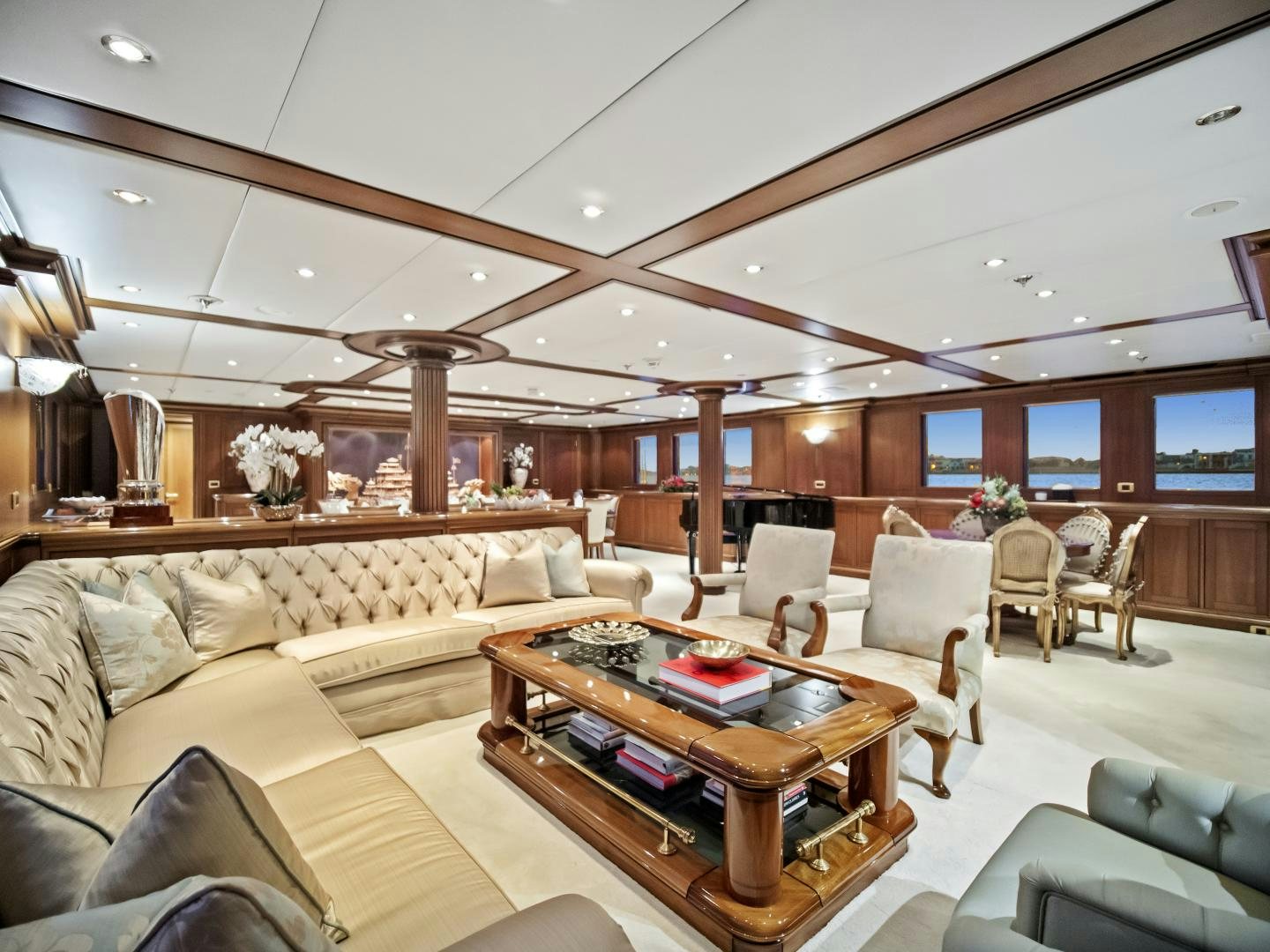 a living room with a large sofa and a coffee table aboard THE LANGLEY Yacht for Sale