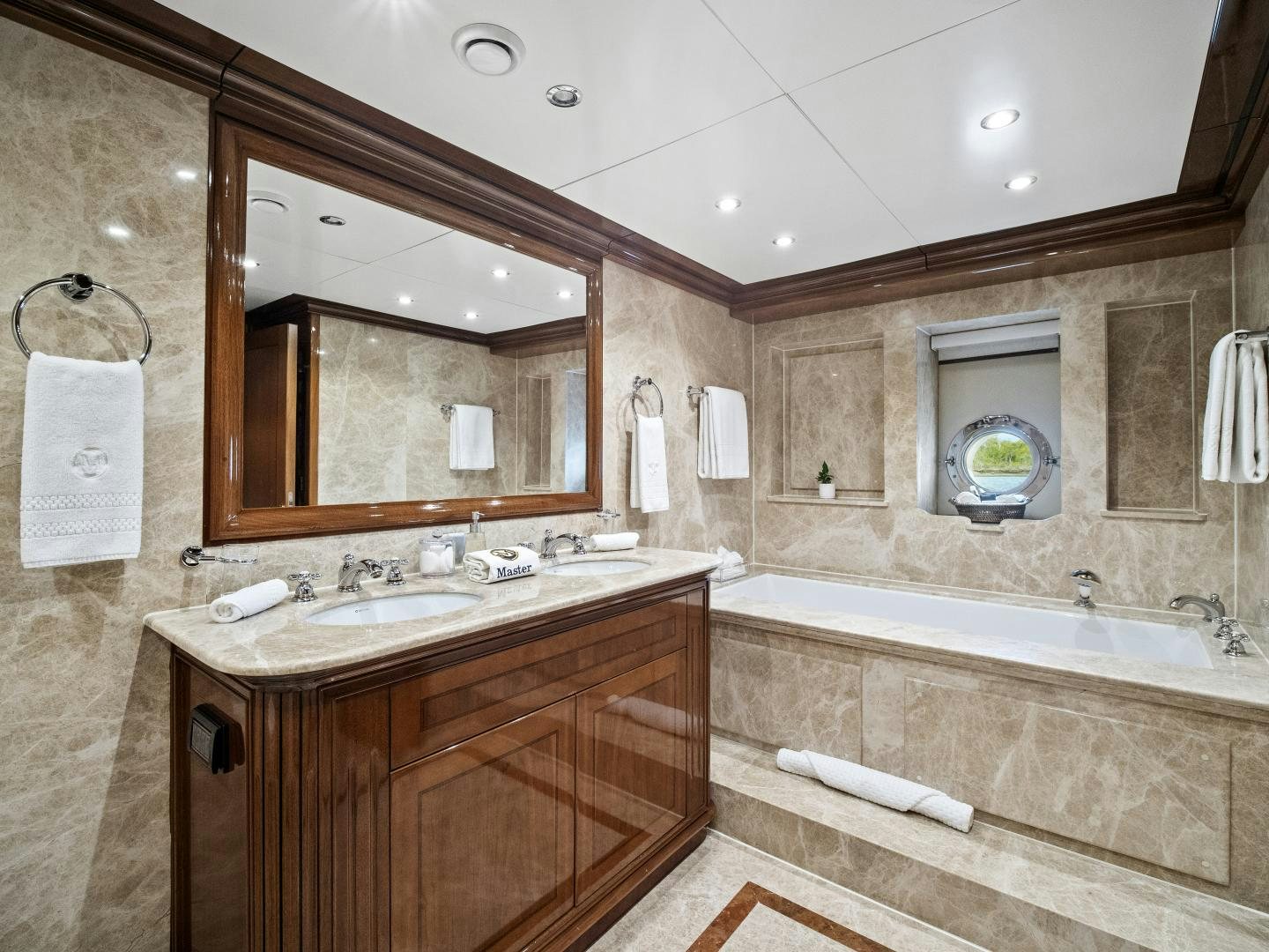 a bathroom with a sink and a bathtub aboard THE LANGLEY Yacht for Sale