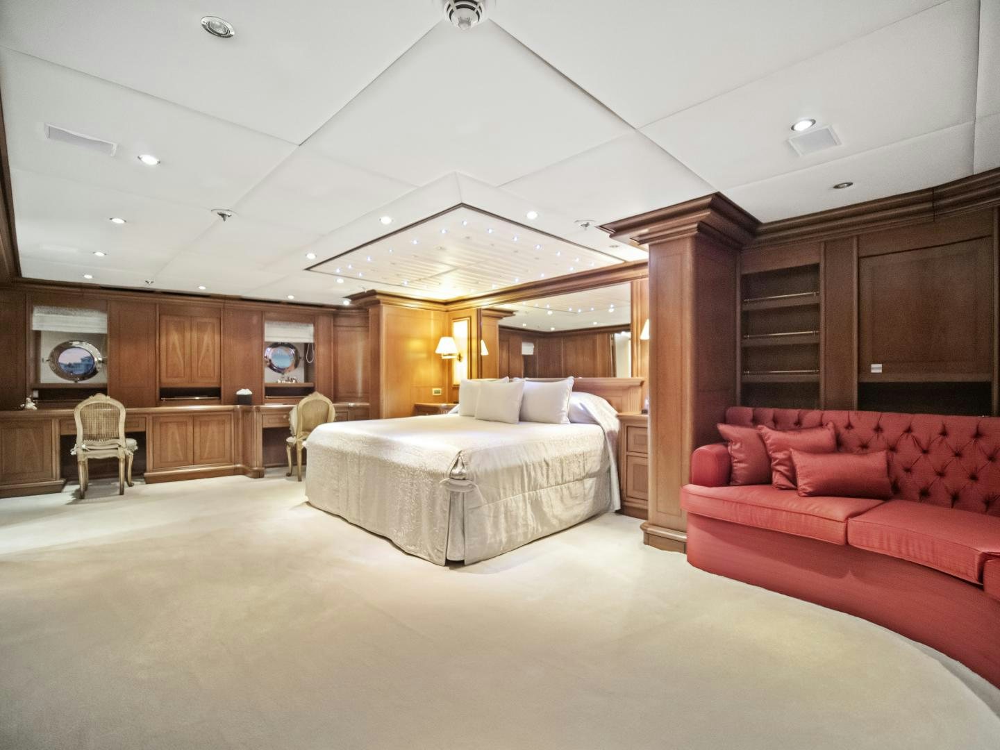 a large bedroom with a bed and a couch aboard THE LANGLEY Yacht for Sale