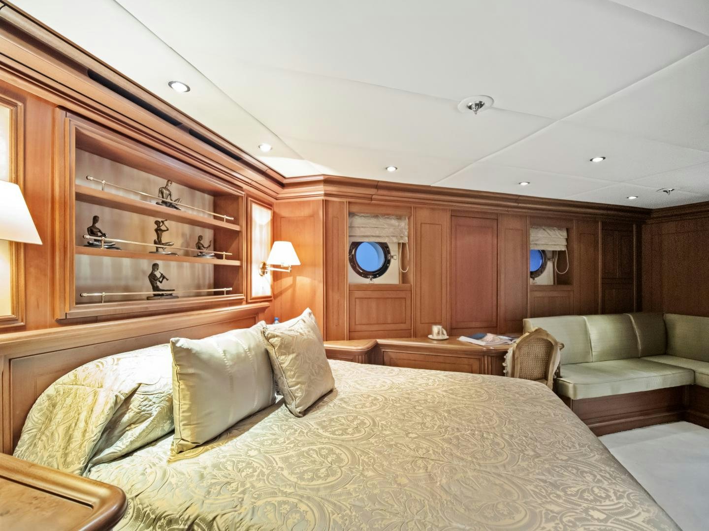 a bedroom with a bed and a couch aboard THE LANGLEY Yacht for Sale