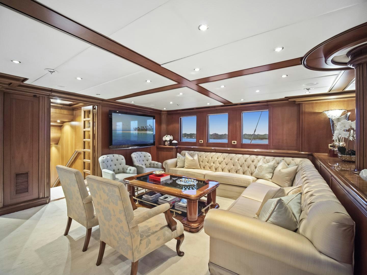 a living room with a couch and a tv aboard THE LANGLEY Yacht for Sale