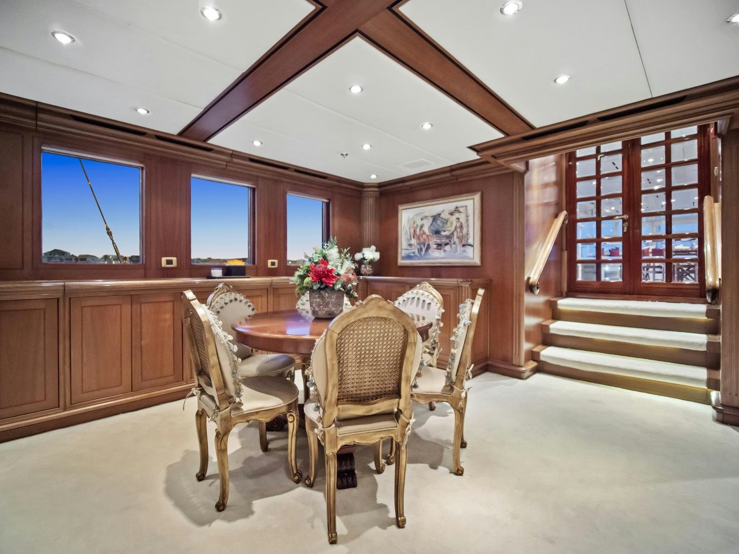 a dining room with a wood table aboard THE LANGLEY Yacht for Sale