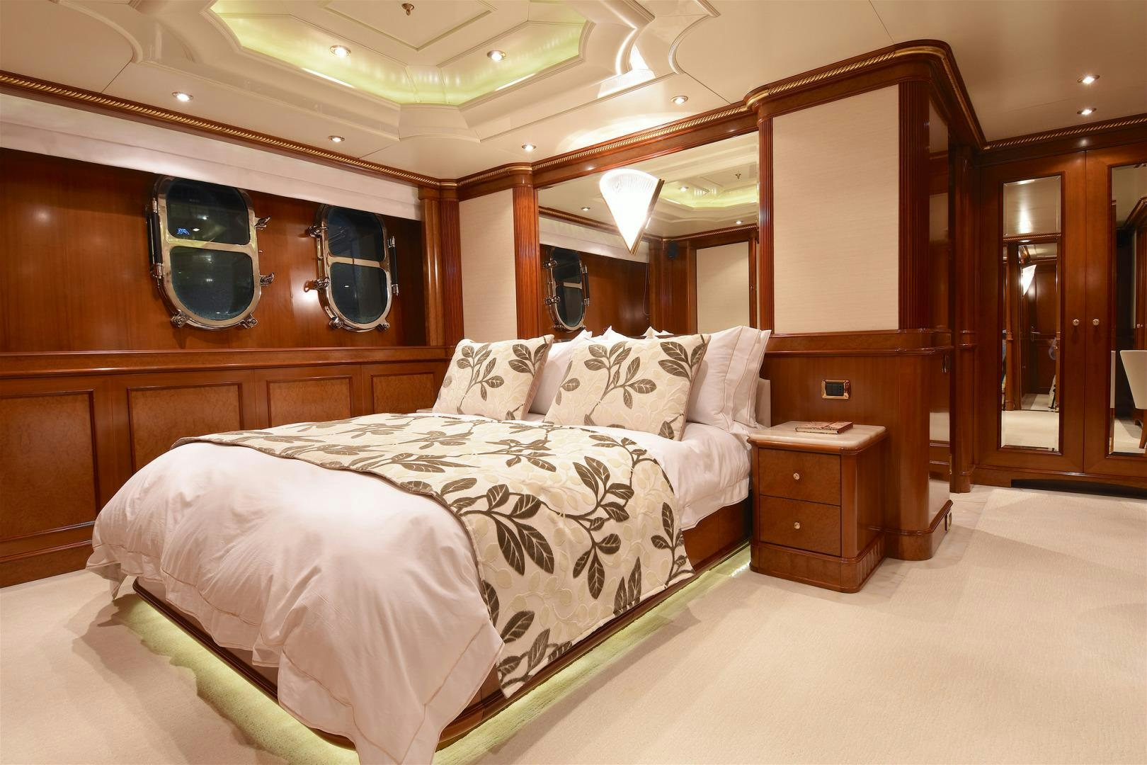a room with a bed and a mirror aboard NEXT CHAPTER Yacht for Sale