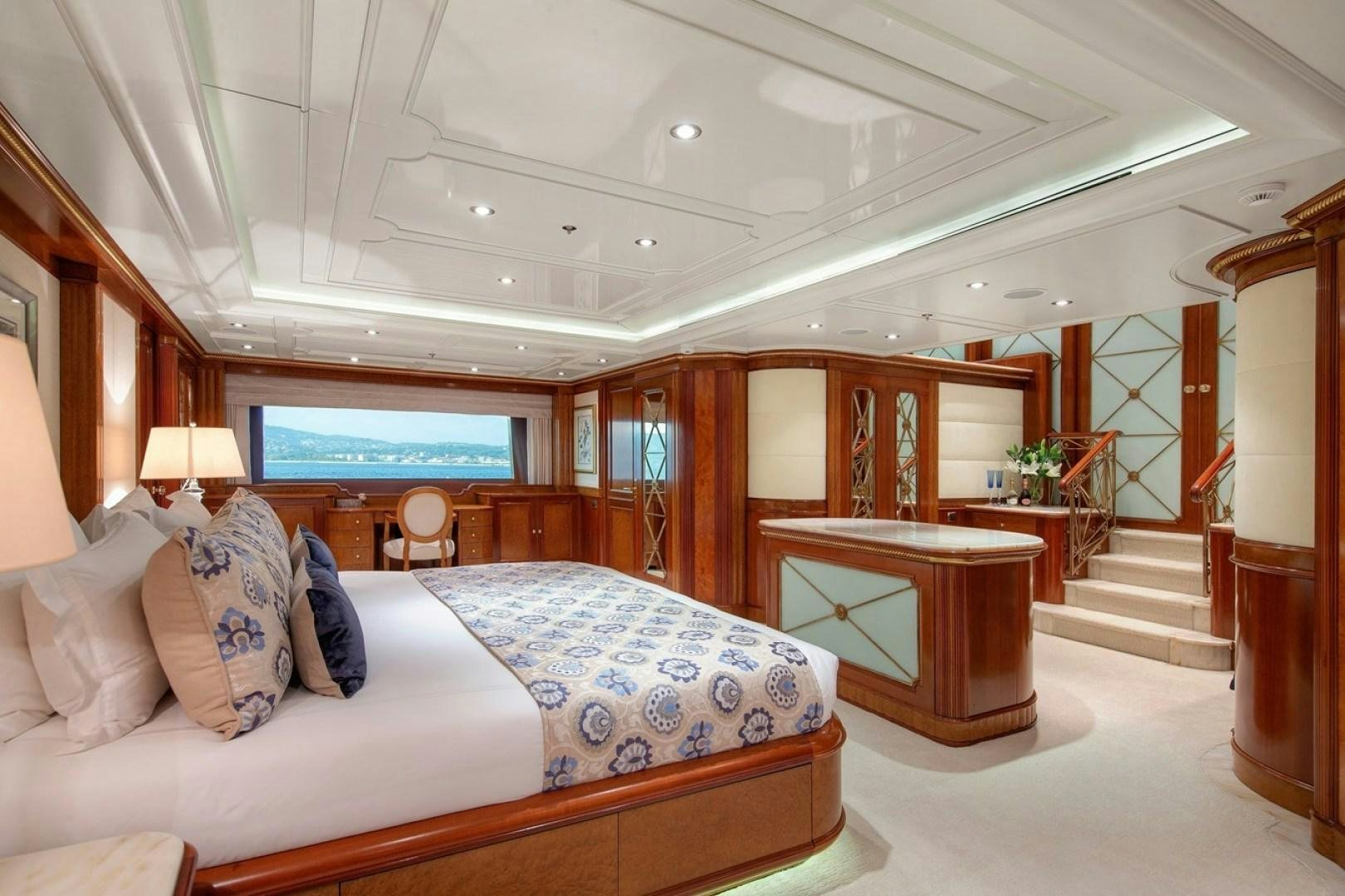 a bedroom with a bed and a desk aboard NEXT CHAPTER Yacht for Sale