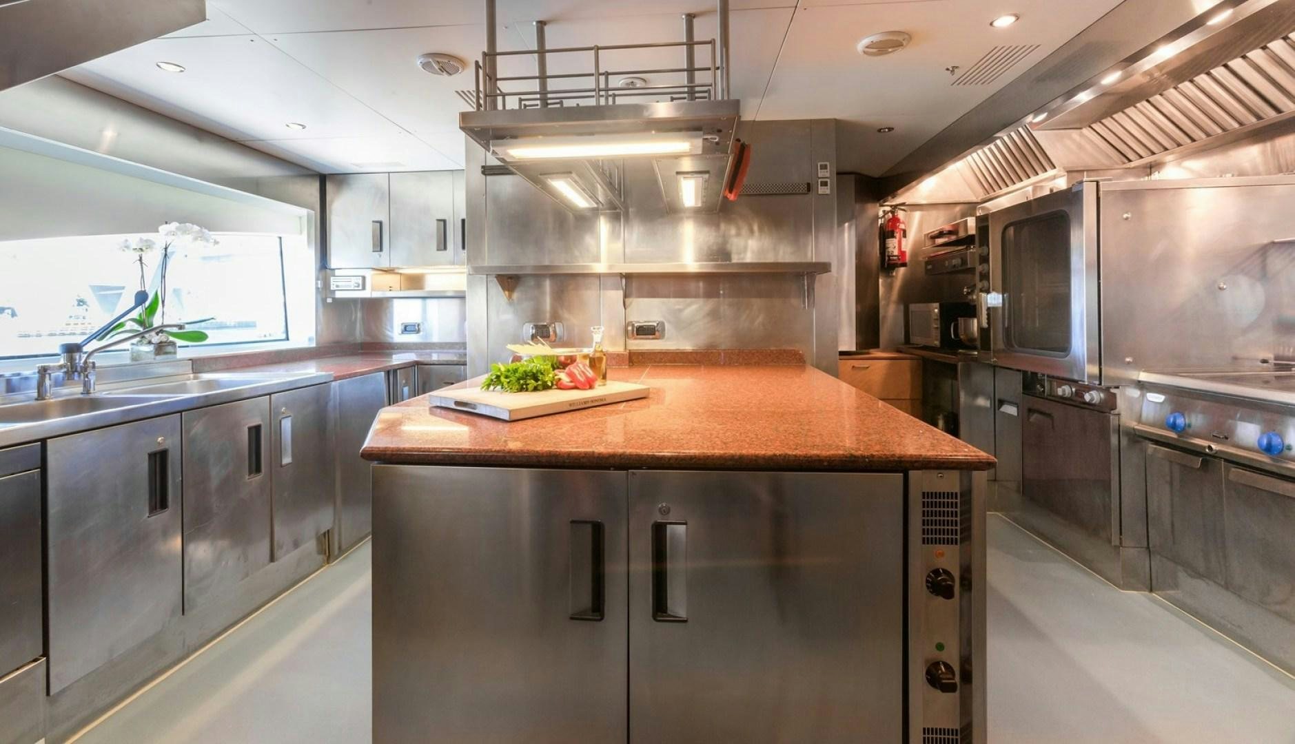 a kitchen with a large island aboard NEXT CHAPTER Yacht for Sale