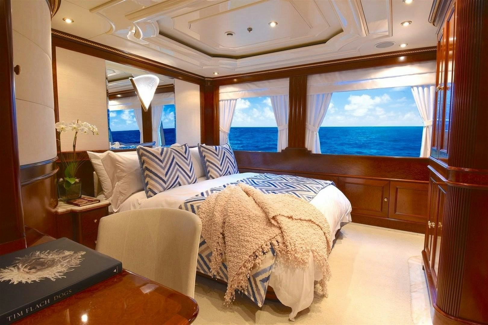 a room with a bed and a window aboard NEXT CHAPTER Yacht for Sale
