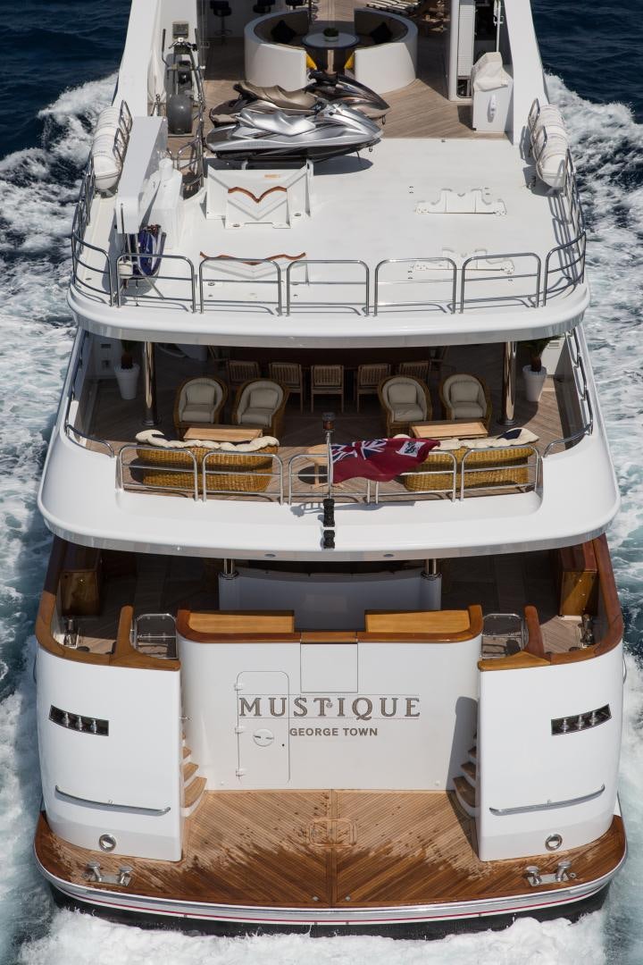 a white boat with a gold and silver boat on it aboard MUSTIQUE Yacht for Sale