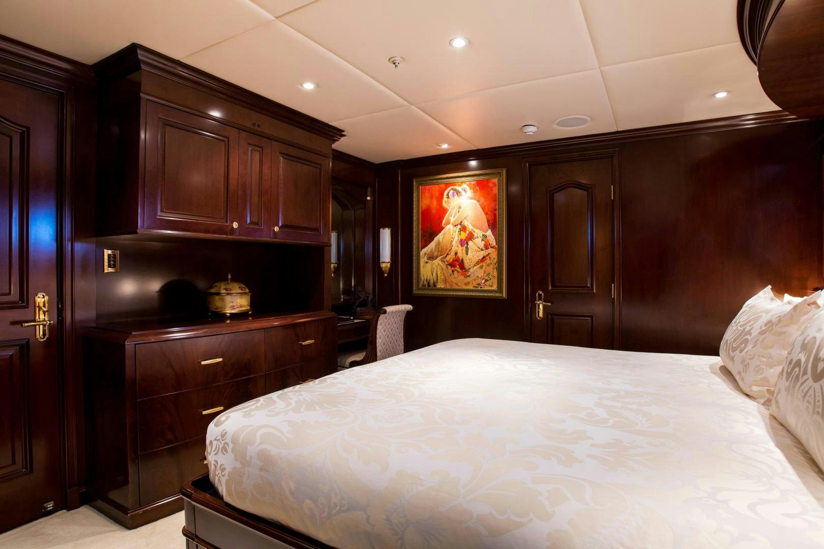 a bedroom with a bed and cabinets aboard MUSTIQUE Yacht for Sale