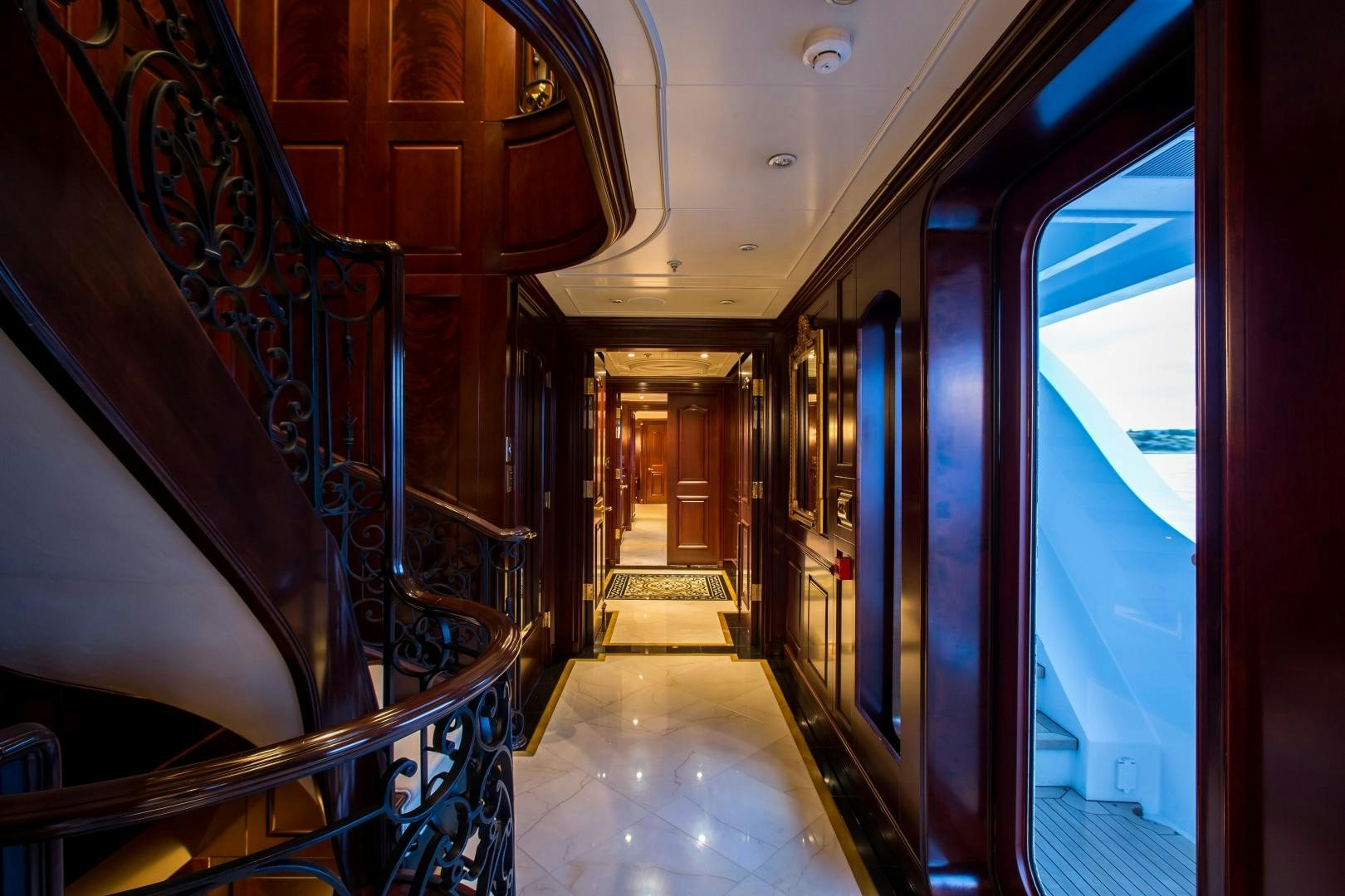 a hallway with escalators aboard MUSTIQUE Yacht for Sale