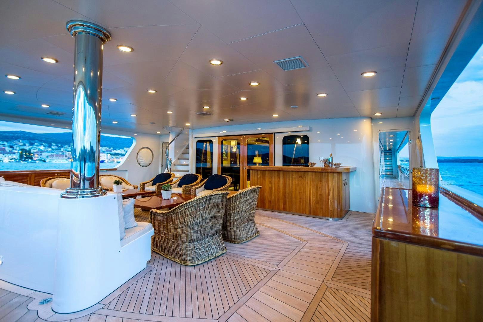 a large room with a large fireplace aboard MUSTIQUE Yacht for Sale