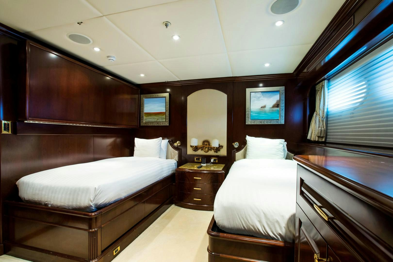 a room with a couple of beds aboard MUSTIQUE Yacht for Sale