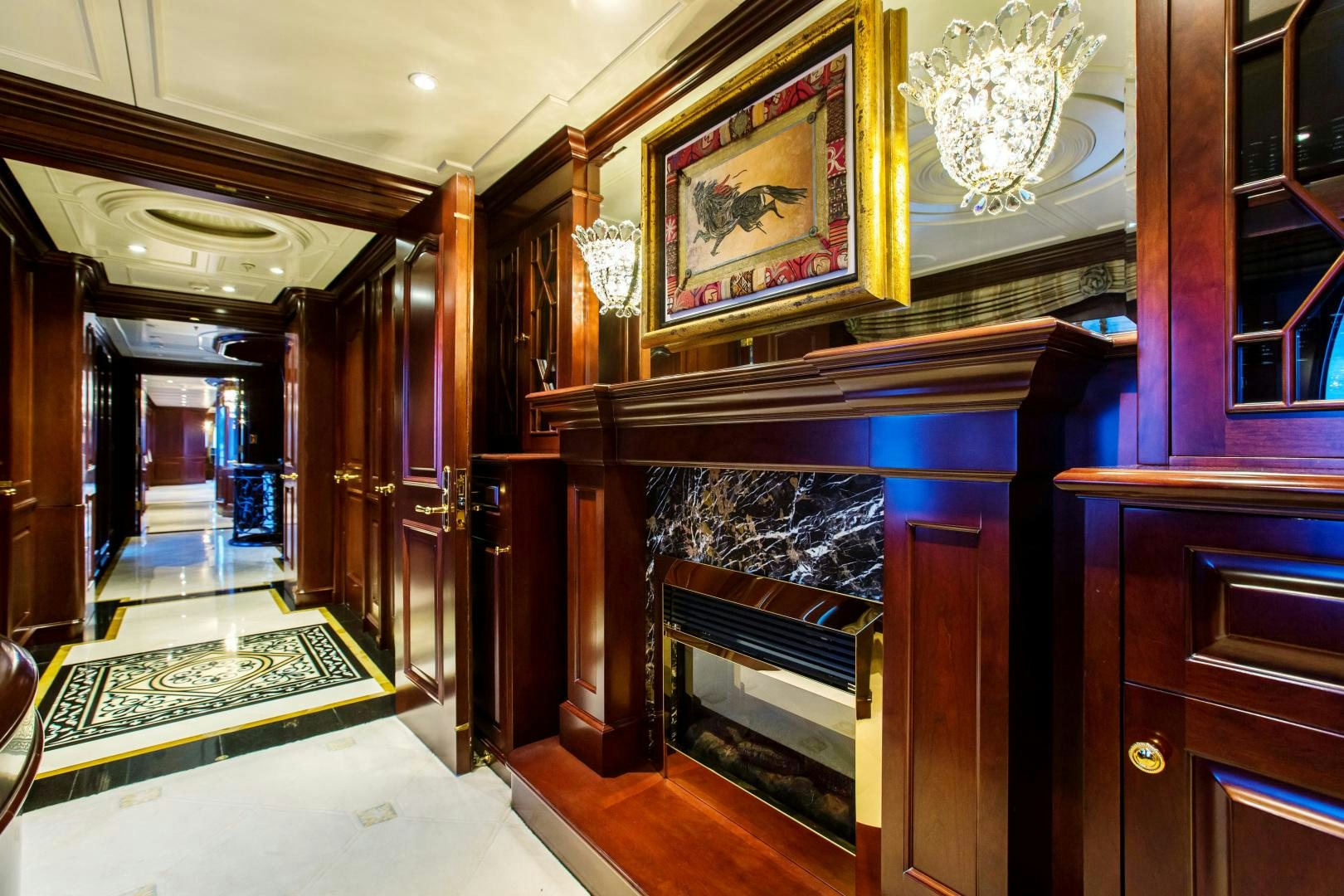 a room with a fireplace and a mirror aboard MUSTIQUE Yacht for Sale