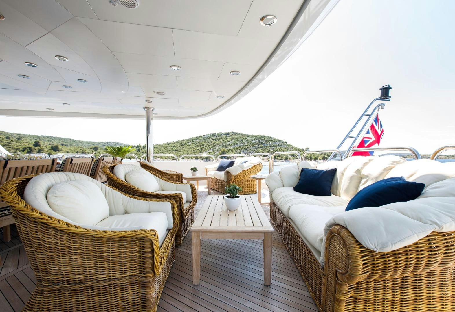 a patio with chairs and a table aboard MUSTIQUE Yacht for Sale