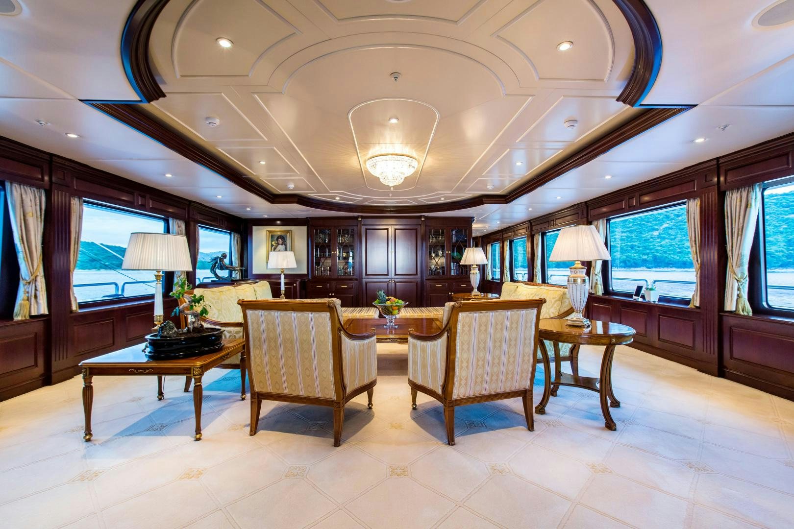 a large room with a table and chairs aboard MUSTIQUE Yacht for Sale