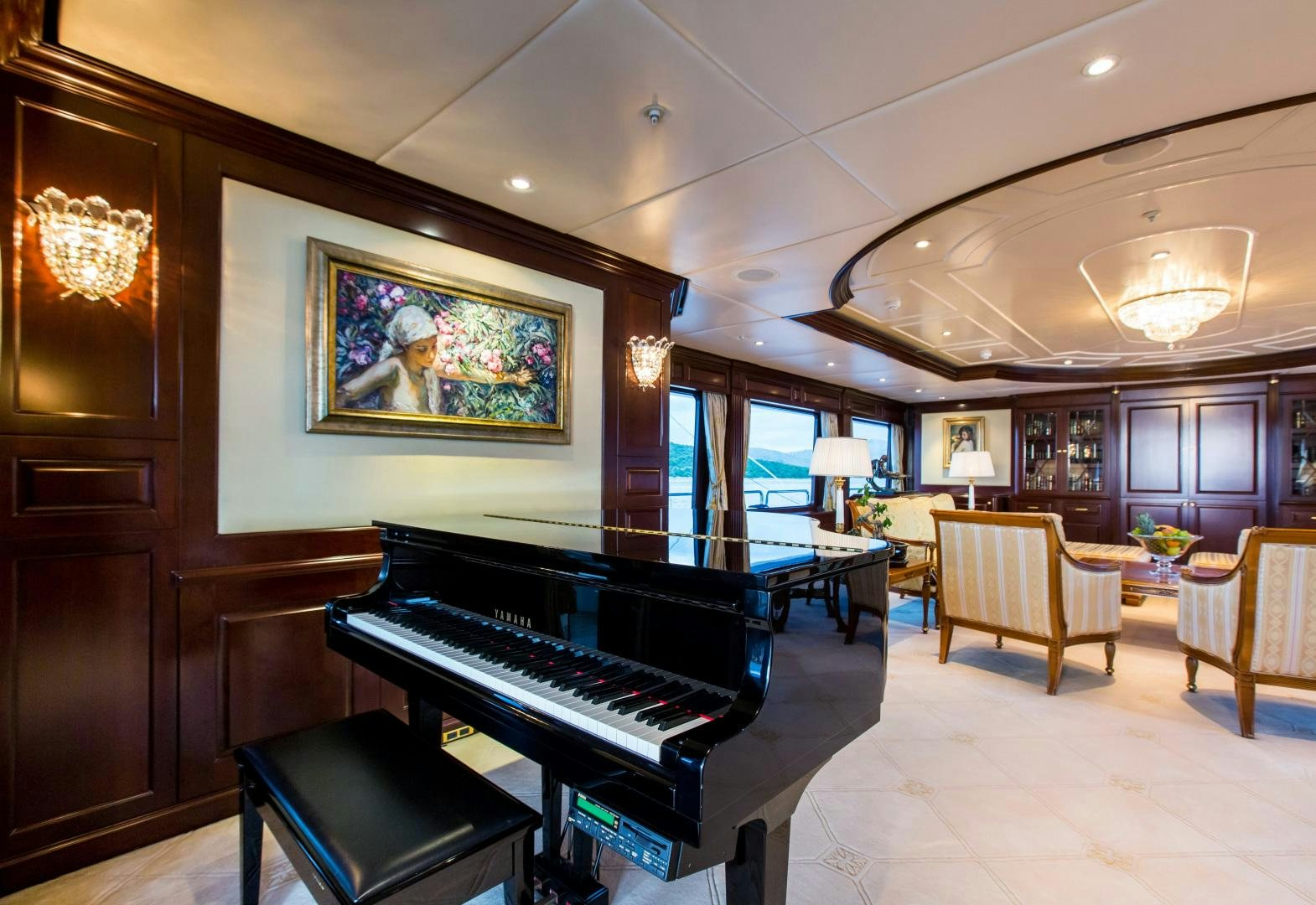 a large room with a piano and a piano aboard MUSTIQUE Yacht for Sale
