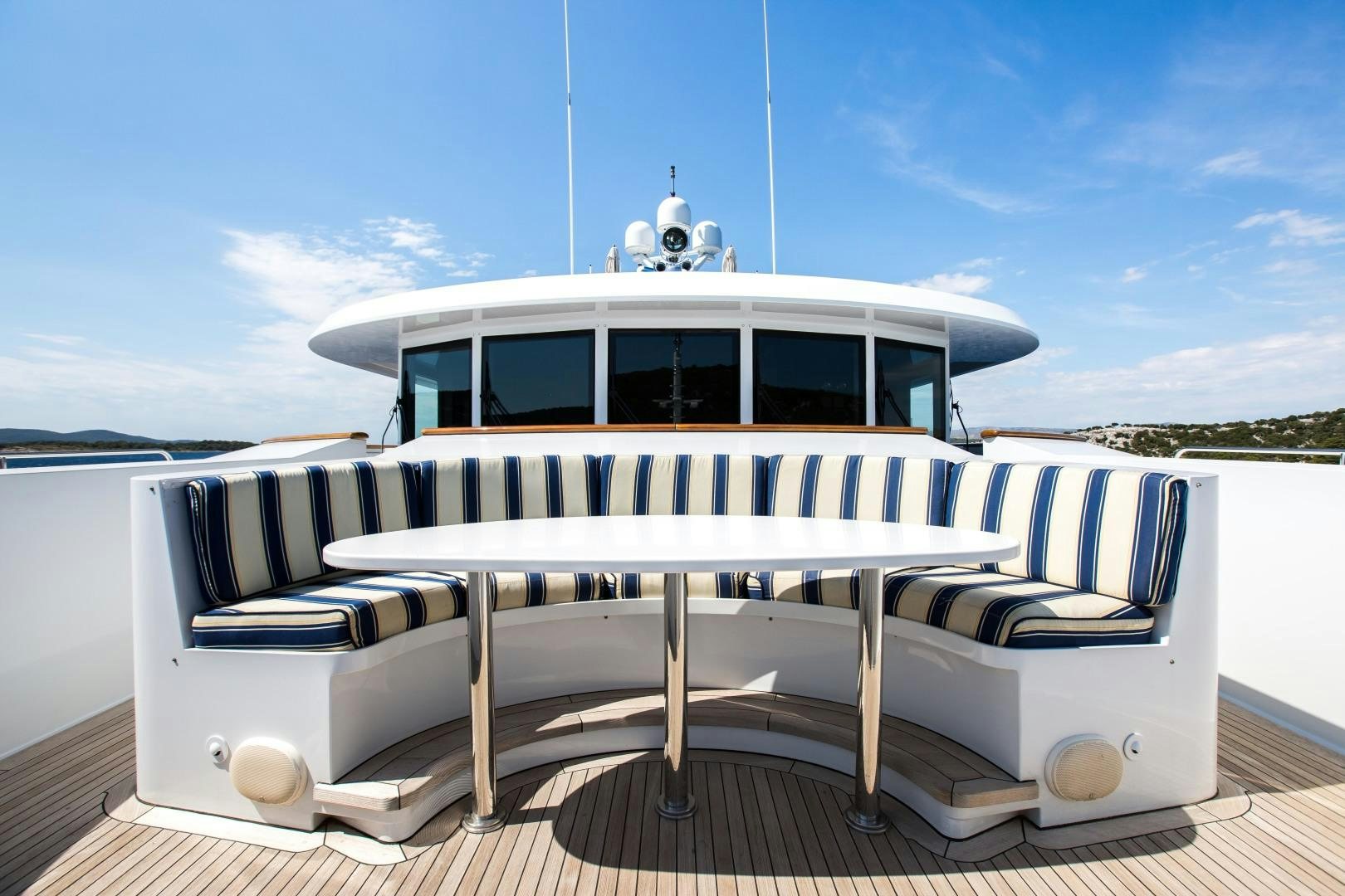 a white and black boat on a dock aboard MUSTIQUE Yacht for Sale