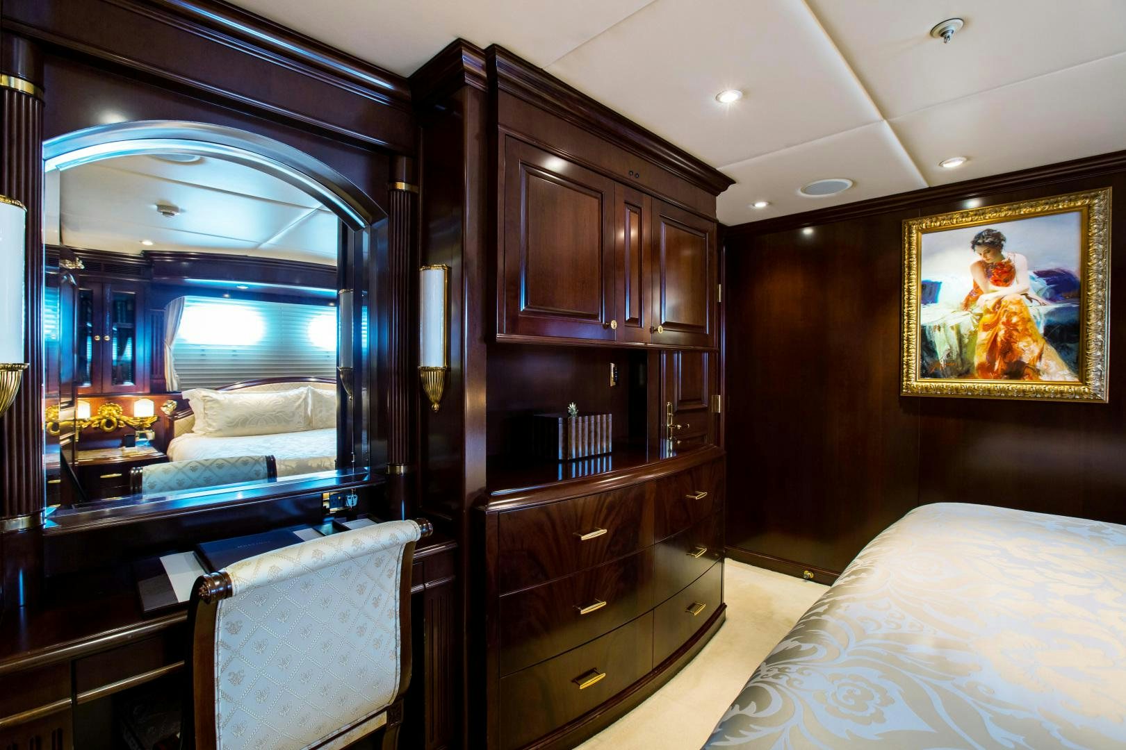 a bedroom with a mirror and a bed aboard MUSTIQUE Yacht for Sale