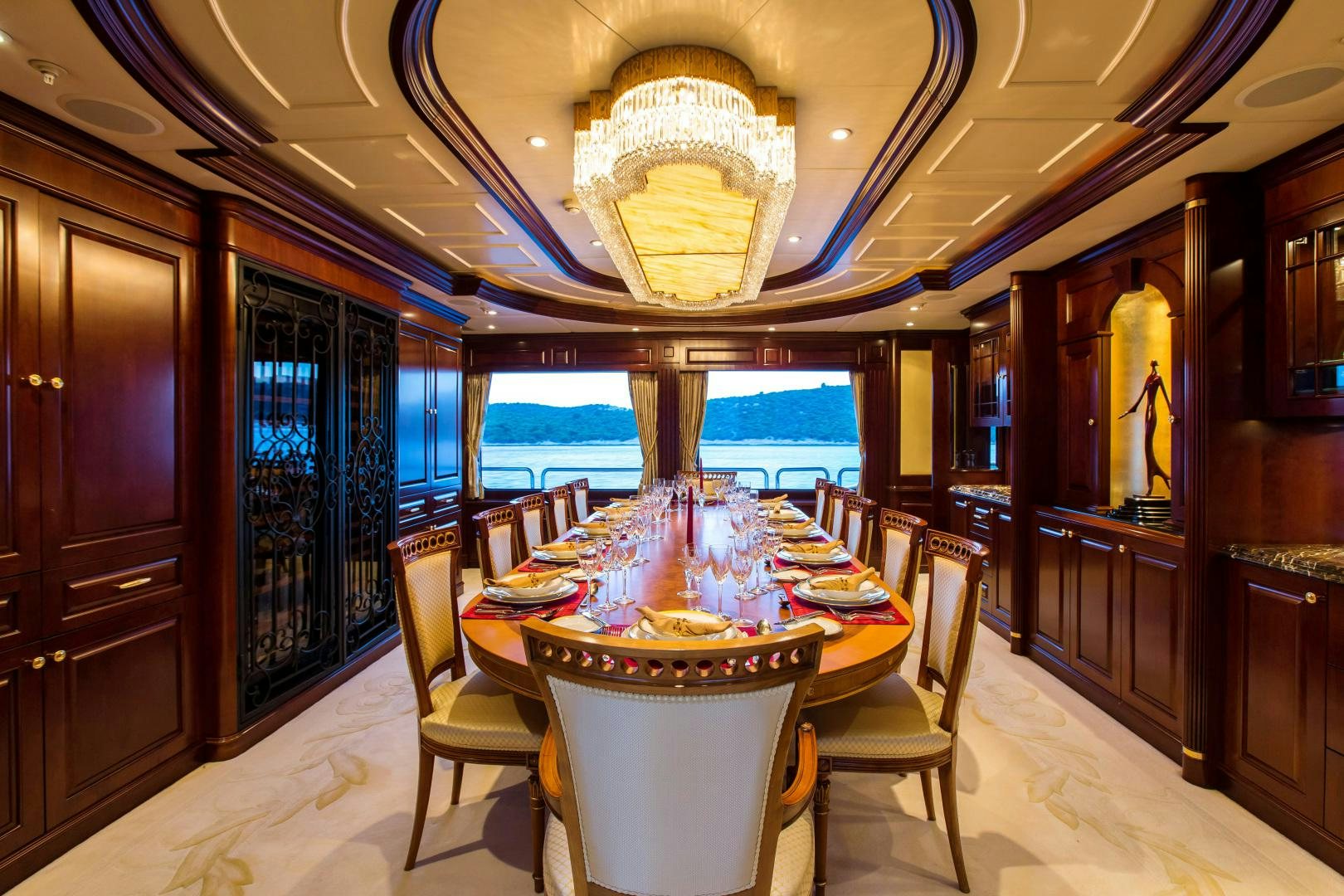 a dining room with a table and chairs aboard MUSTIQUE Yacht for Sale