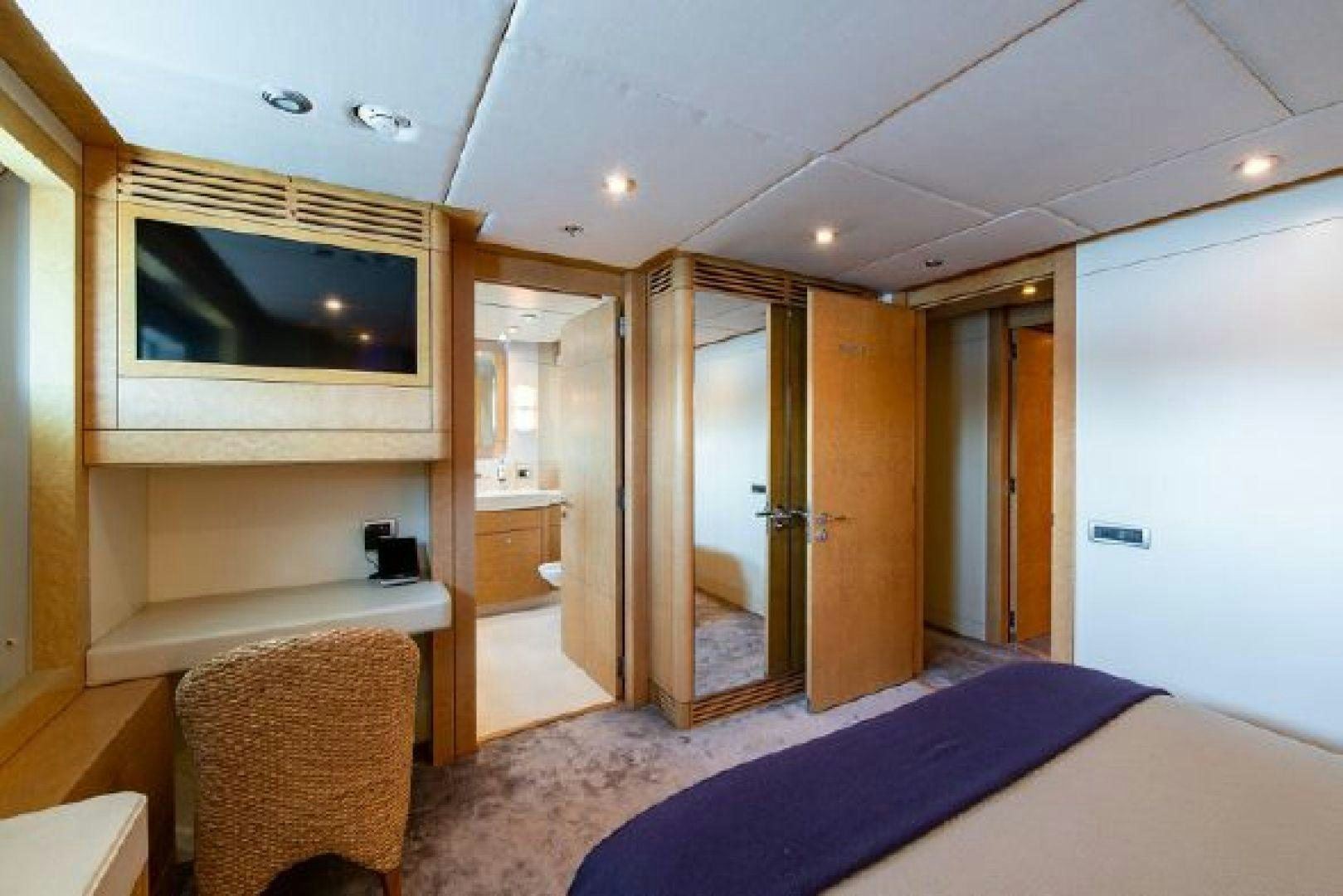 a bedroom with a bed and a television aboard 174 OCEANFAST MIZU Yacht for Sale