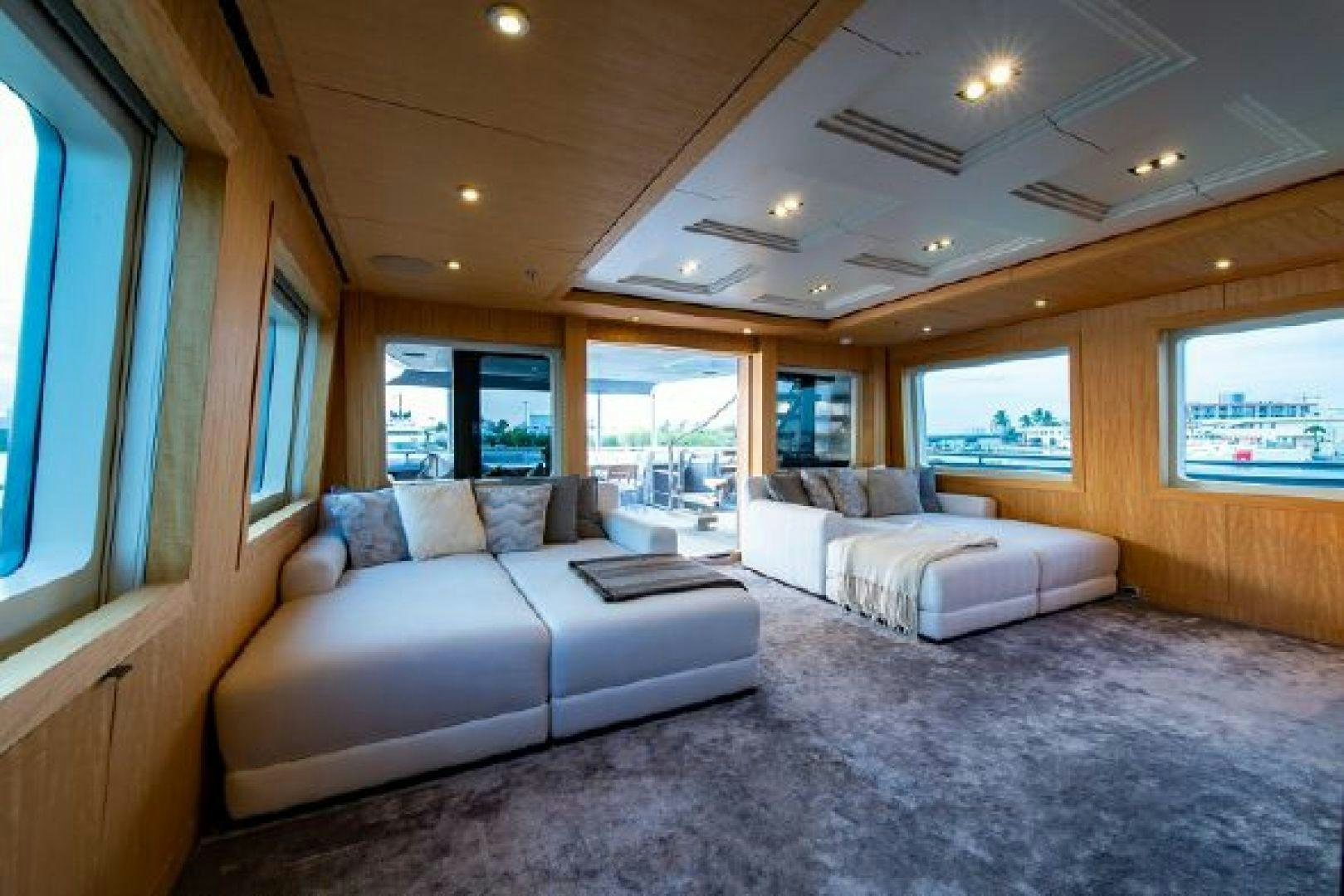 a living room with a couch and a large window aboard 174 OCEANFAST MIZU Yacht for Sale