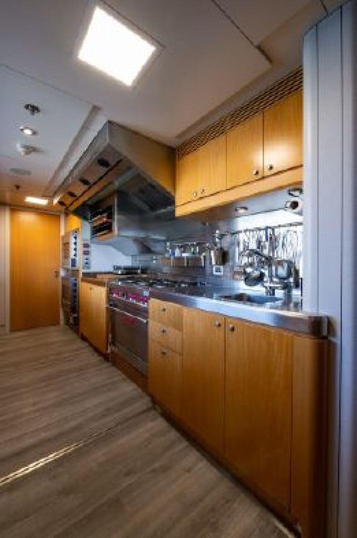 a kitchen with wooden cabinets aboard 174 OCEANFAST MIZU Yacht for Sale