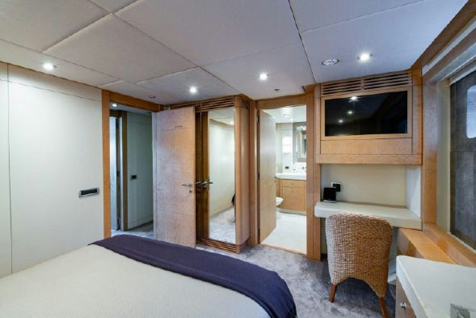 a bedroom with a bed and a mirror aboard 174 OCEANFAST MIZU Yacht for Sale