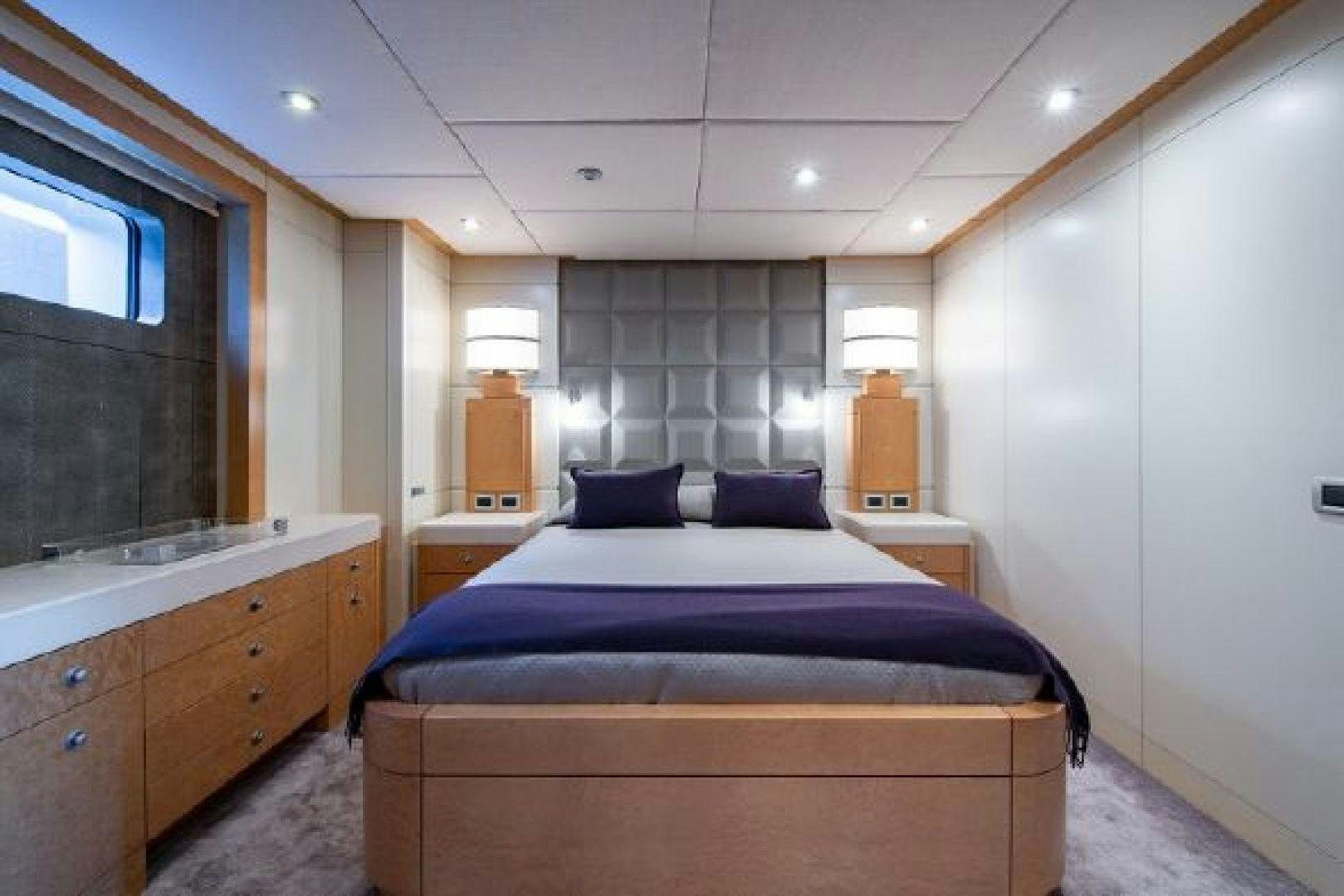 a bedroom with a bed and a dresser aboard 174 OCEANFAST MIZU Yacht for Sale