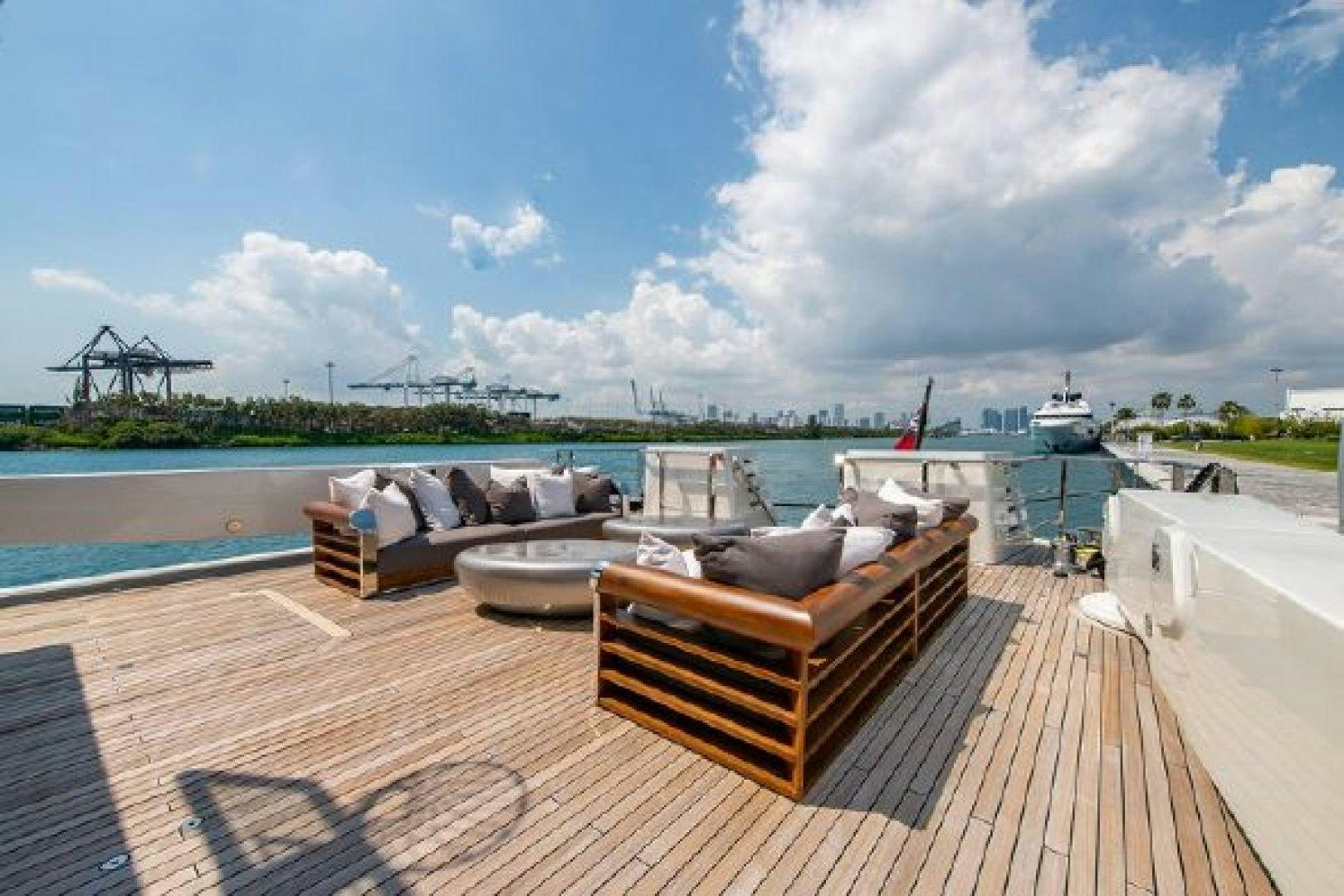 a deck with a view of a body of water and boats in the background aboard 174 OCEANFAST MIZU Yacht for Sale