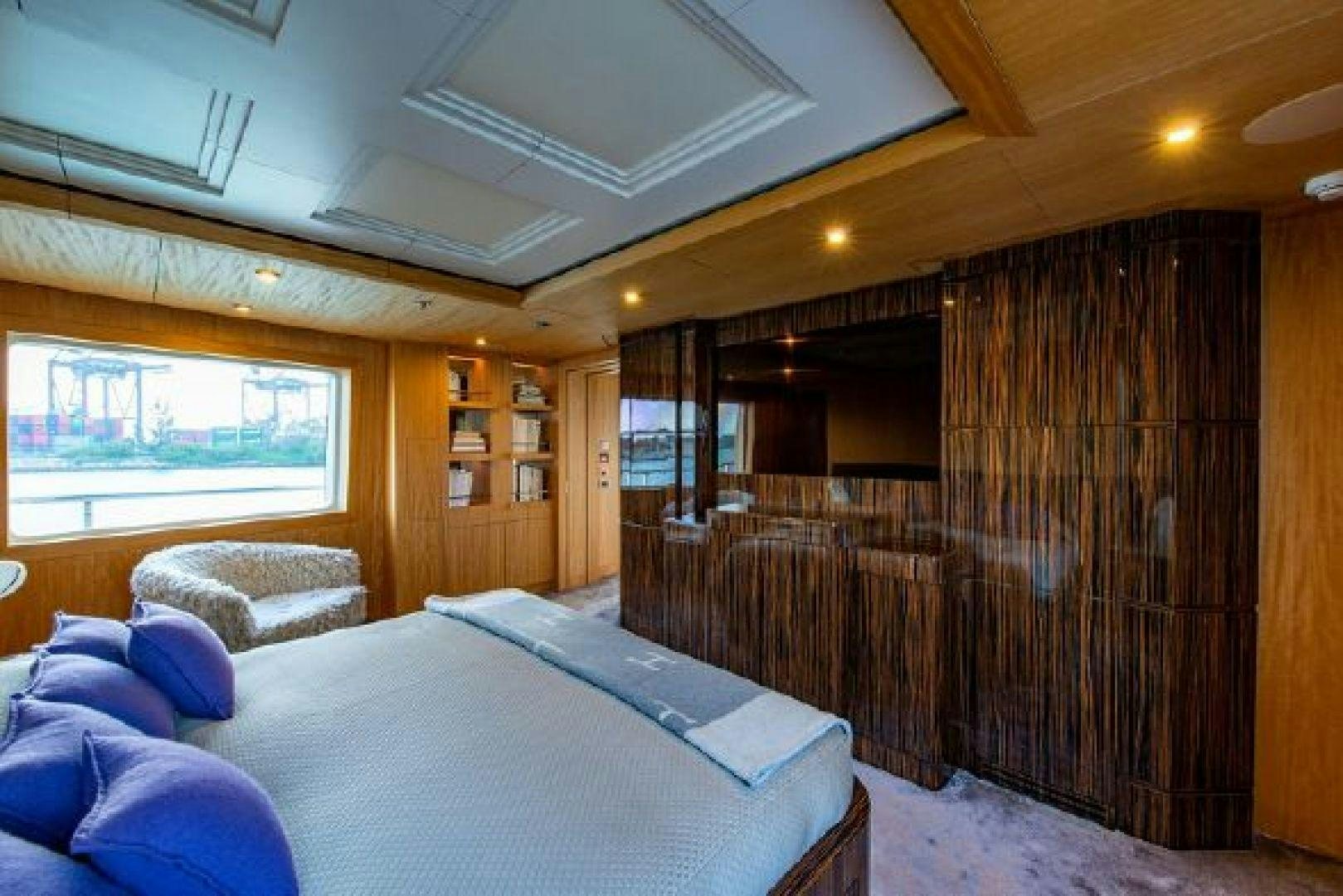 a room with a bed and a wood wall aboard 174 OCEANFAST MIZU Yacht for Sale