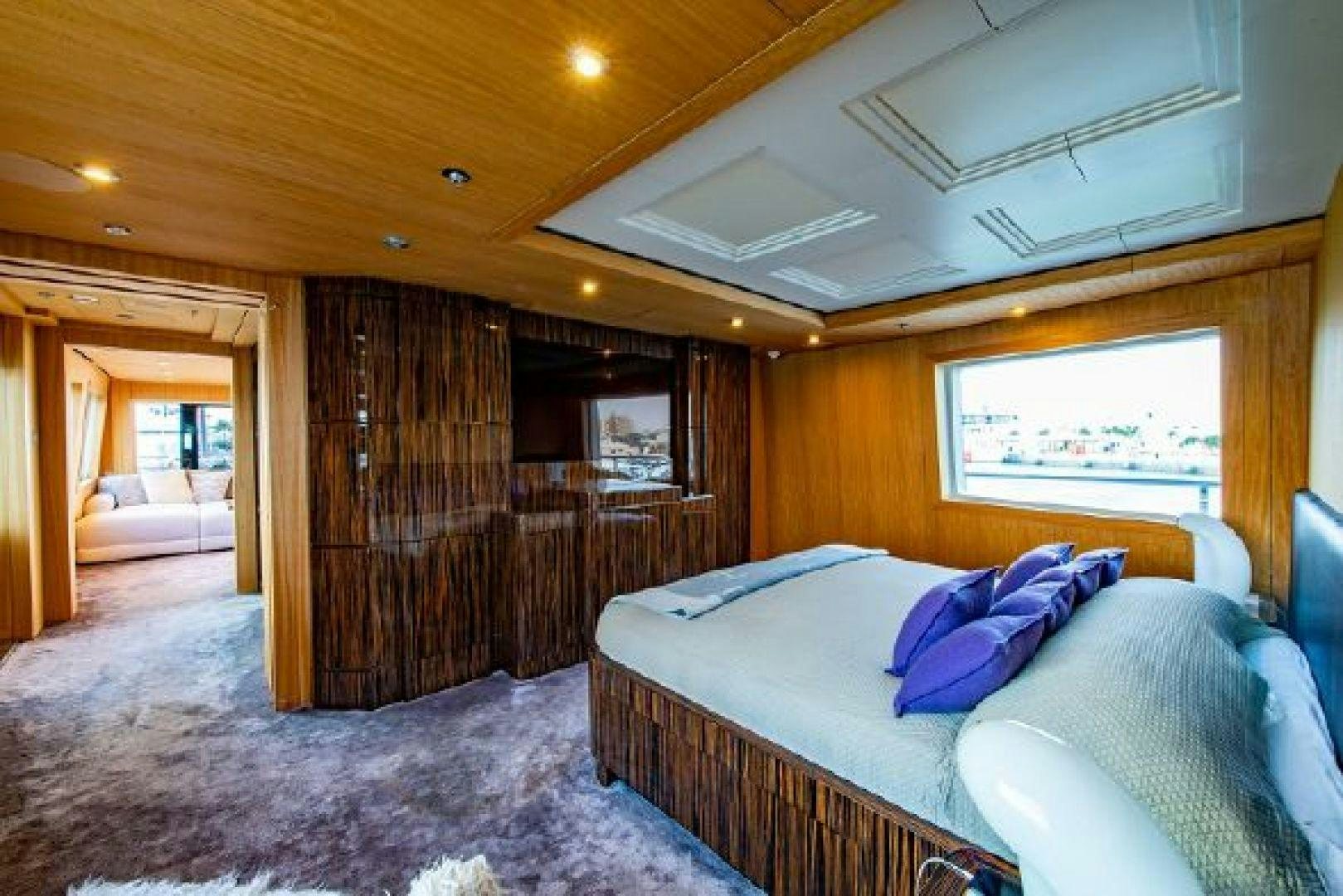 a bedroom with a bed and a wood door aboard 174 OCEANFAST MIZU Yacht for Sale