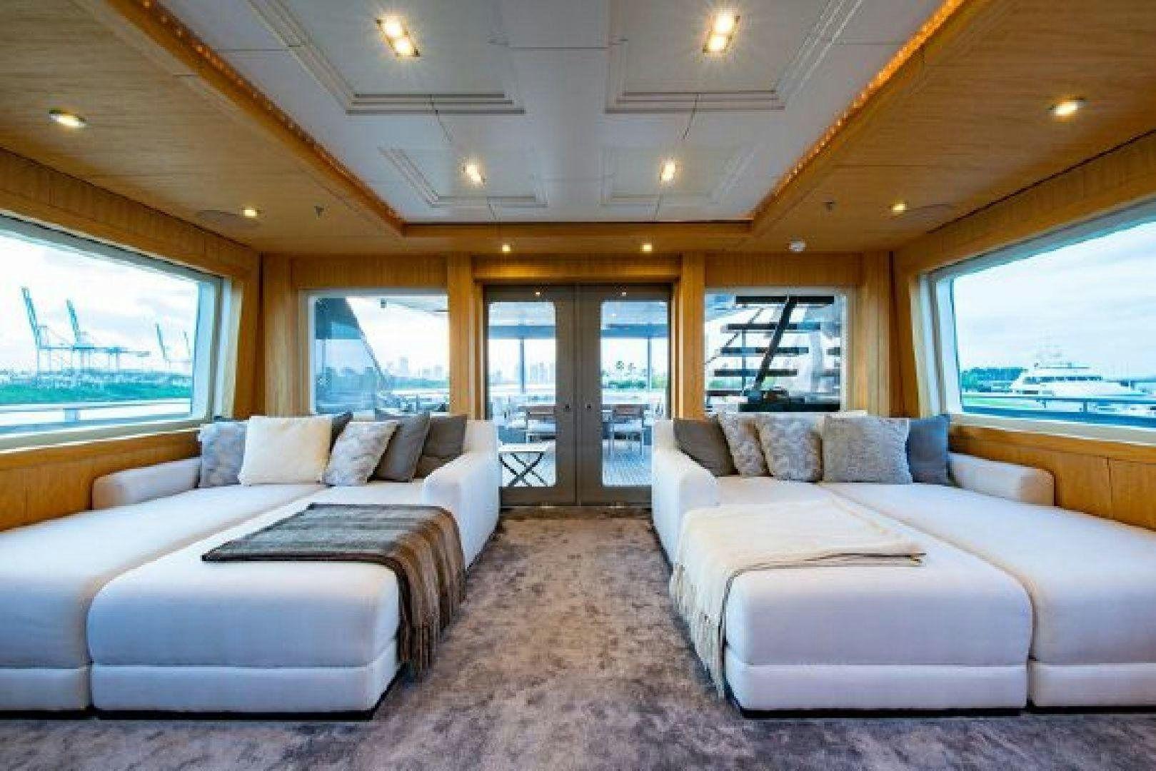 a living room with a couch and a large window aboard 174 OCEANFAST MIZU Yacht for Sale