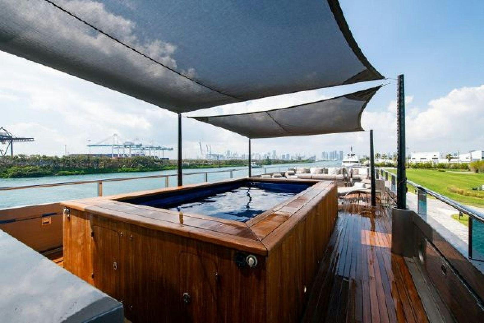 a covered deck with a pool aboard 174 OCEANFAST MIZU Yacht for Sale