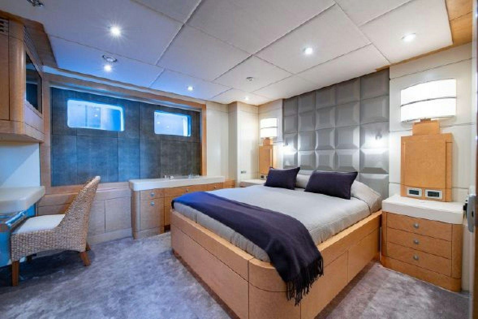 a bedroom with a bed and a desk aboard 174 OCEANFAST MIZU Yacht for Sale