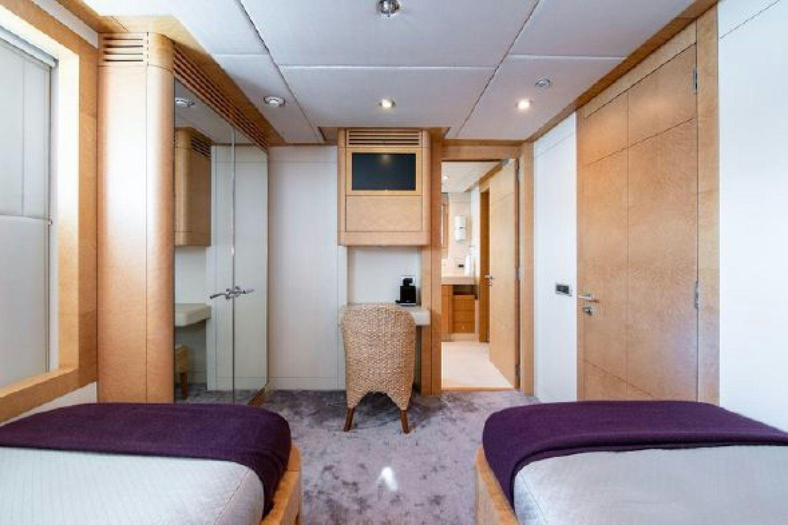 a room with a bed and a table aboard 174 OCEANFAST MIZU Yacht for Sale