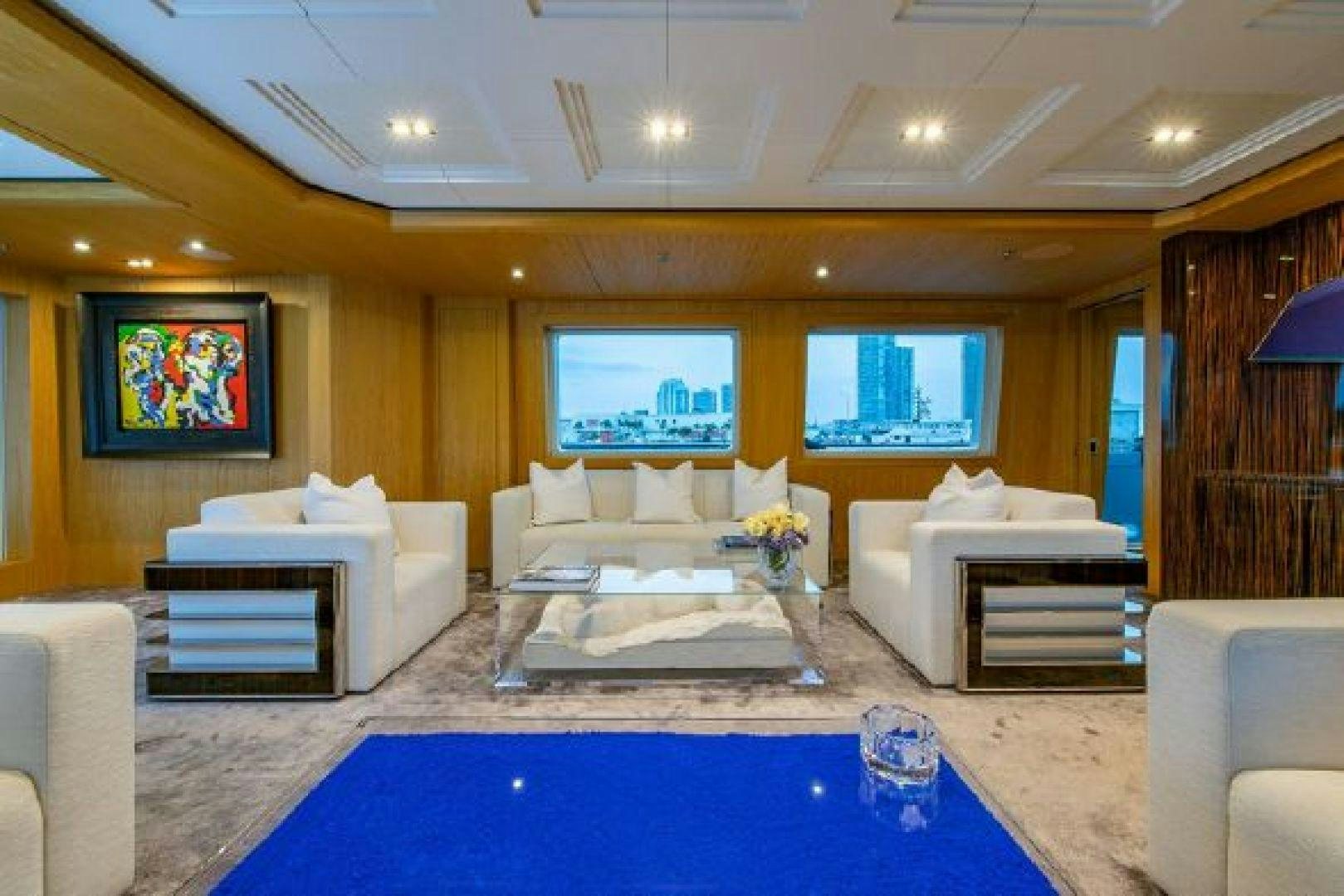 a living room with a blue table aboard 174 OCEANFAST MIZU Yacht for Sale