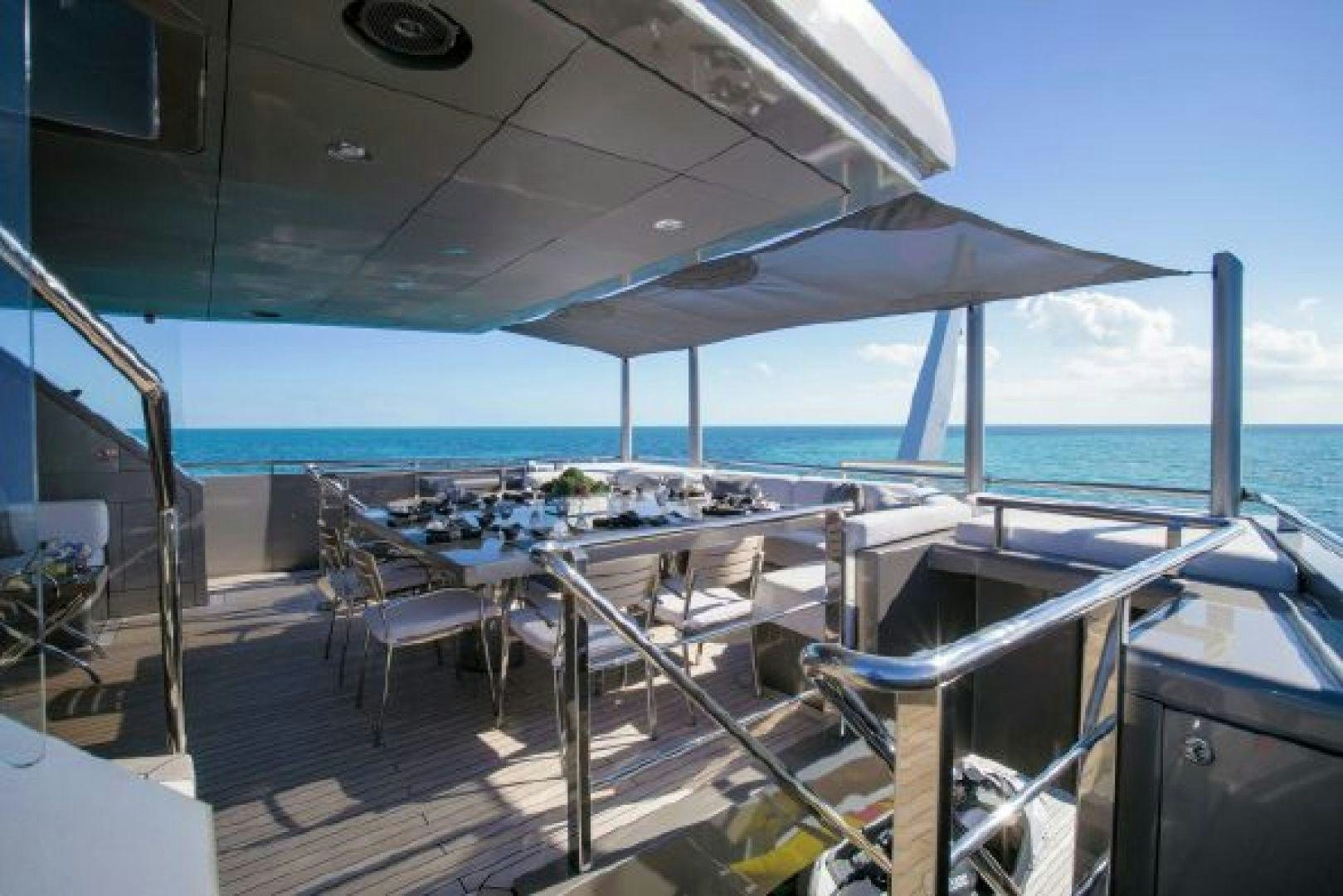 a deck with chairs and tables on it aboard 174 OCEANFAST MIZU Yacht for Sale