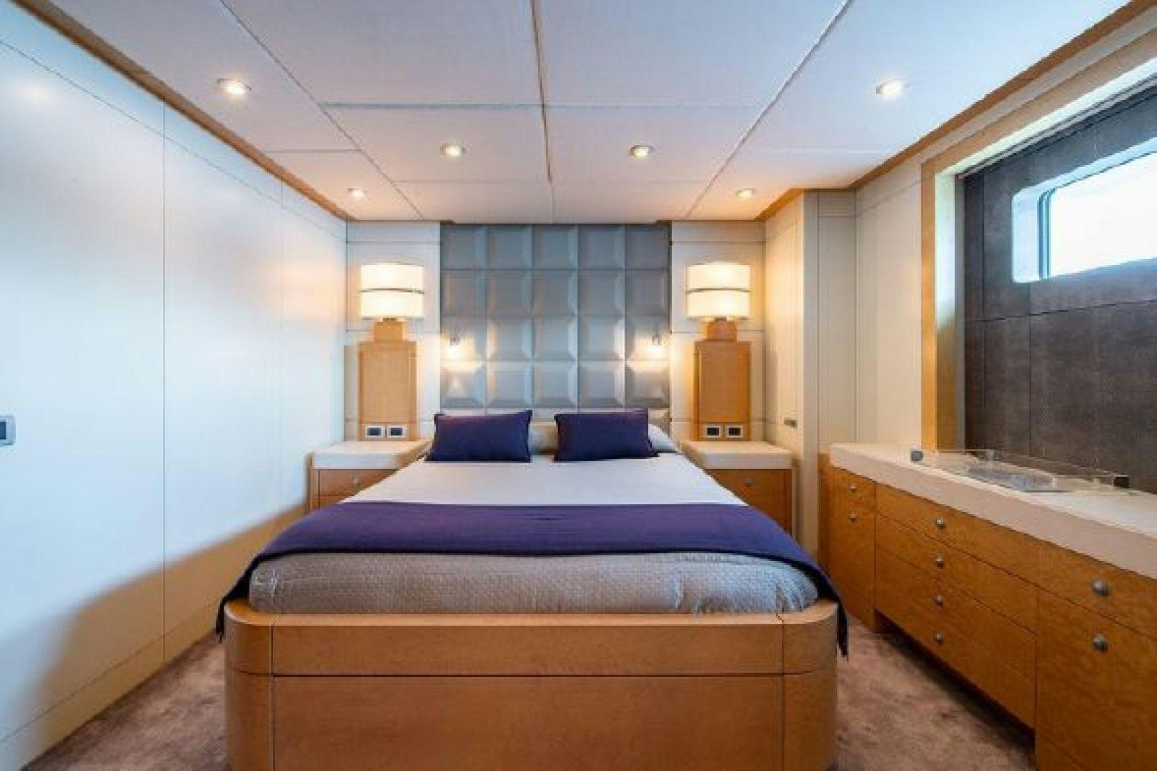 a bedroom with a bed and a window aboard 174 OCEANFAST MIZU Yacht for Sale