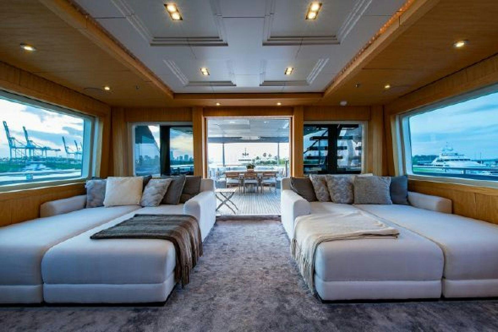 a living room with a couch and a large window aboard 174 OCEANFAST MIZU Yacht for Sale