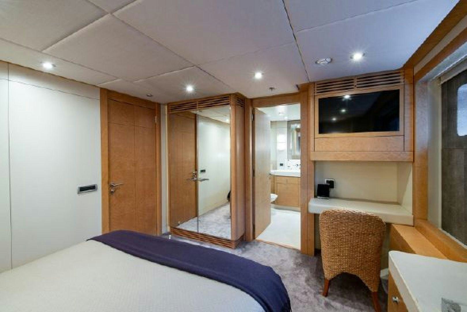 a bedroom with a bed and a closet aboard 174 OCEANFAST MIZU Yacht for Sale