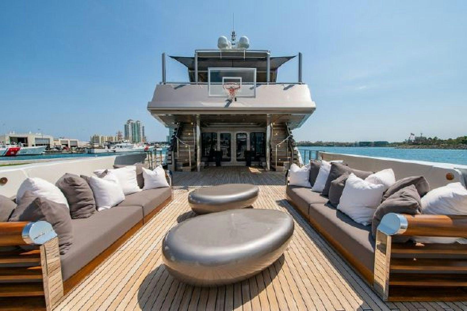 a room with a bed and a large white building with a view of the water and a city aboard 174 OCEANFAST MIZU Yacht for Sale