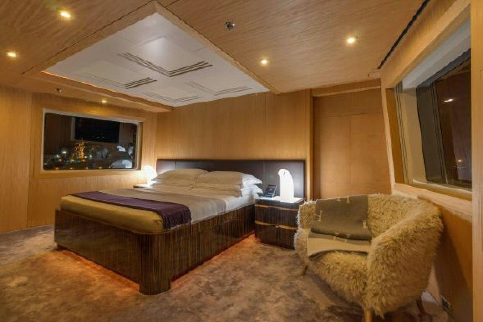 a bedroom with a bed and a couch aboard 174 OCEANFAST MIZU Yacht for Sale