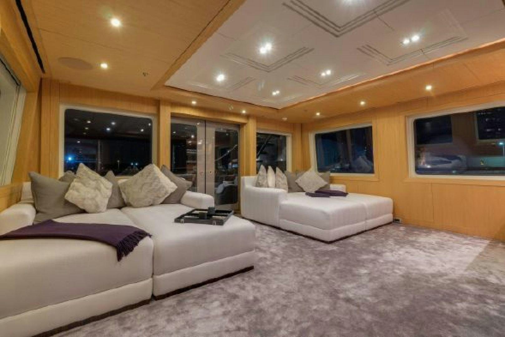 a large living room with a large bed and a large window aboard 174 OCEANFAST MIZU Yacht for Sale