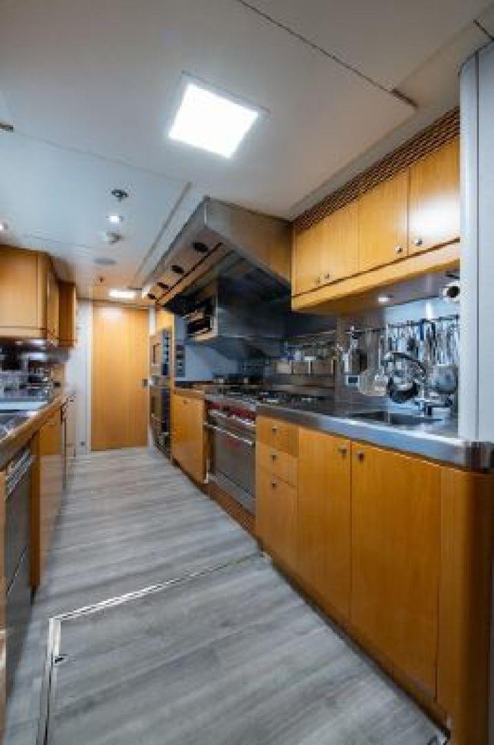 a kitchen with wooden cabinets aboard 174 OCEANFAST MIZU Yacht for Sale