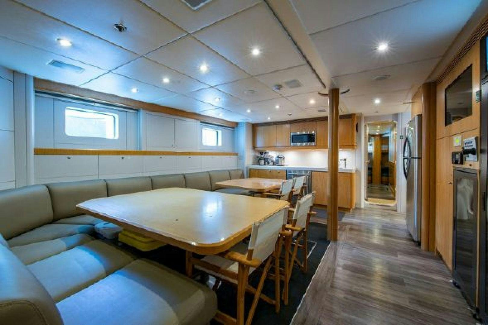 a room with tables and chairs aboard 174 OCEANFAST MIZU Yacht for Sale