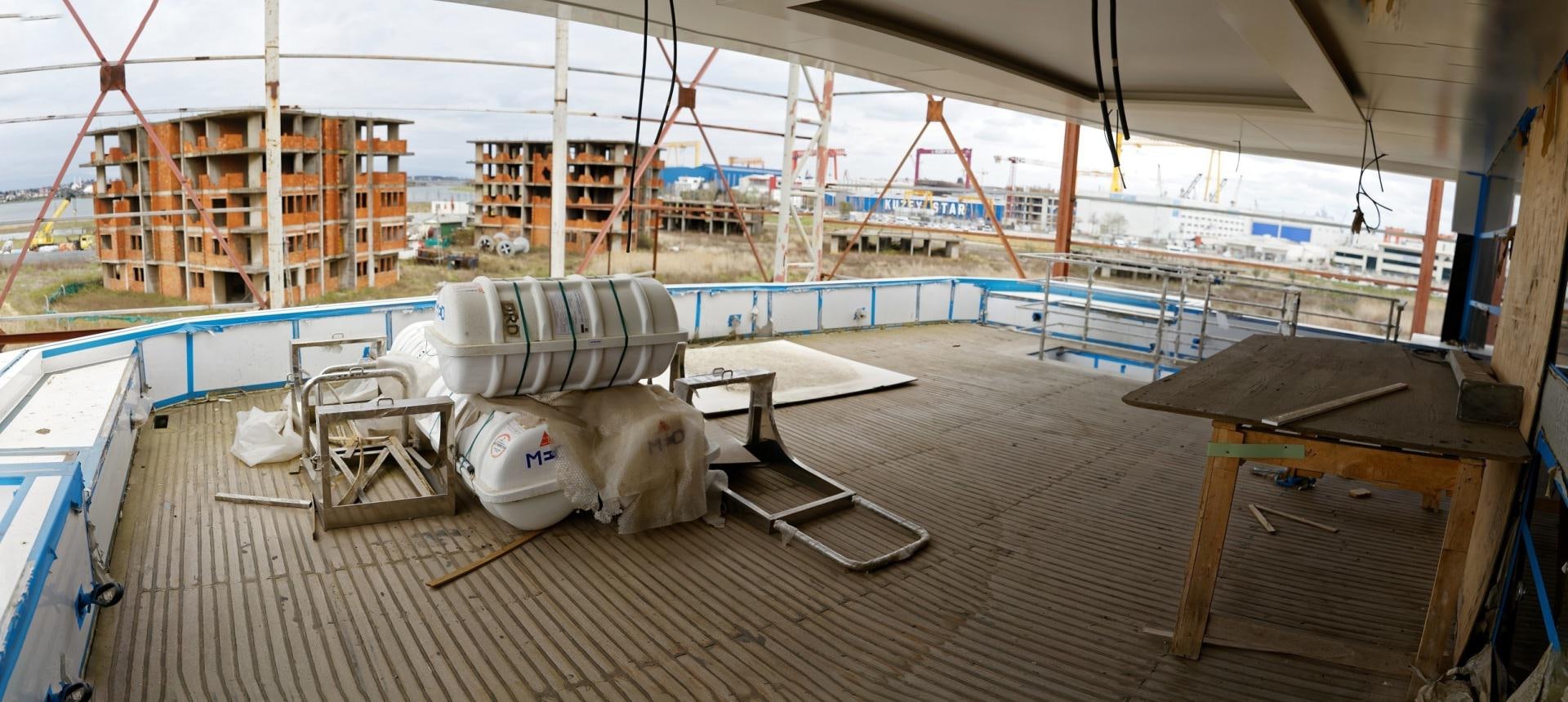 a deck with a pool and a deck with chairs and a table aboard NO NAME Yacht for Sale