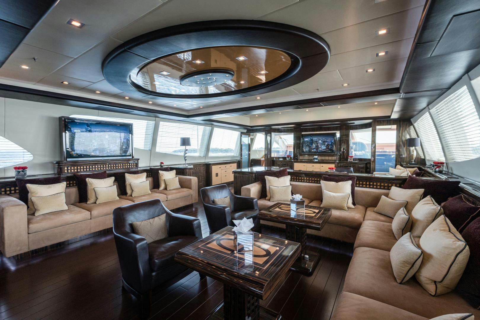 a large living room with a large chandelier aboard SERENITY Yacht for Sale