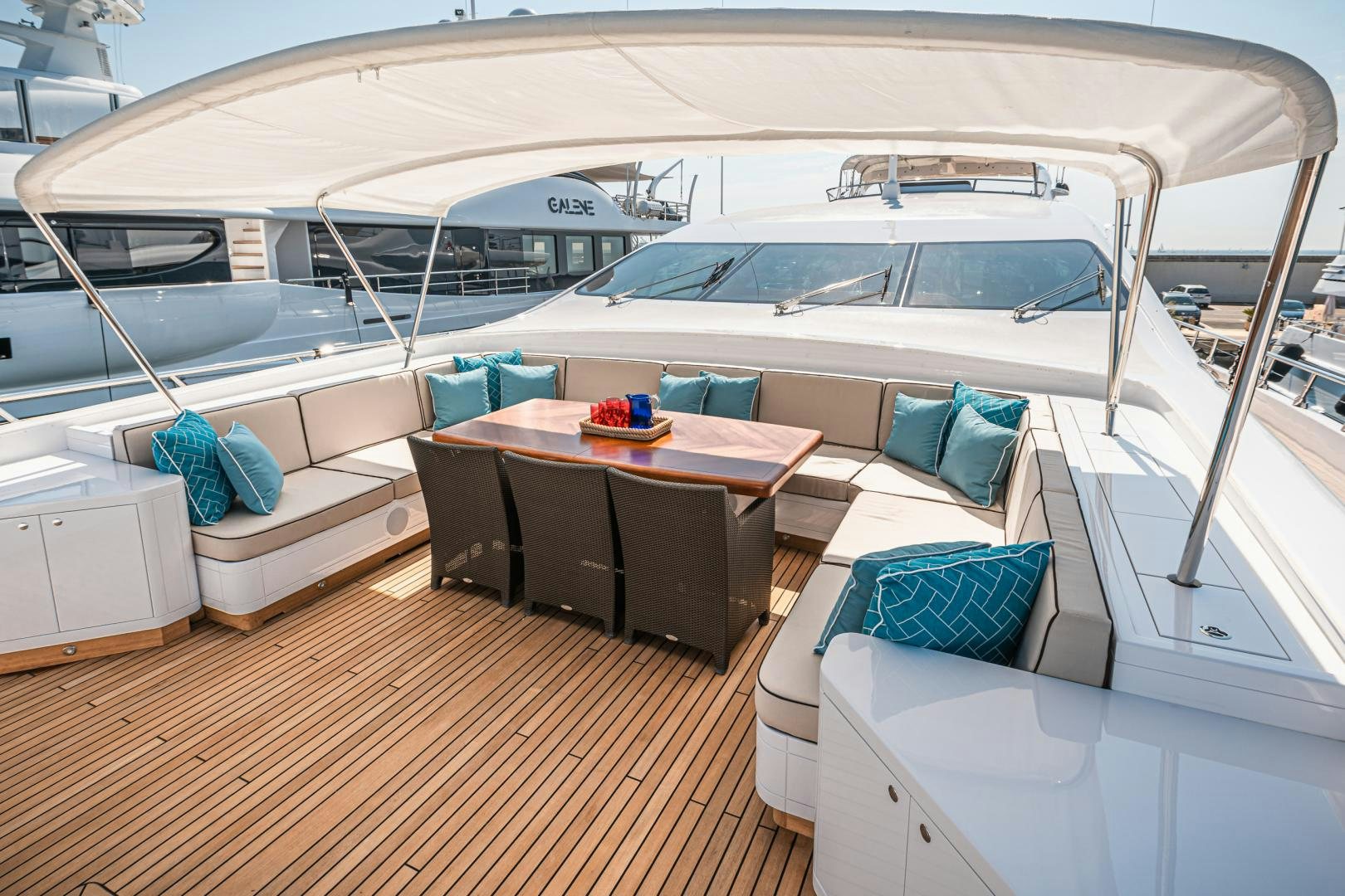 a boat with a table and chairs aboard SERENITY Yacht for Sale