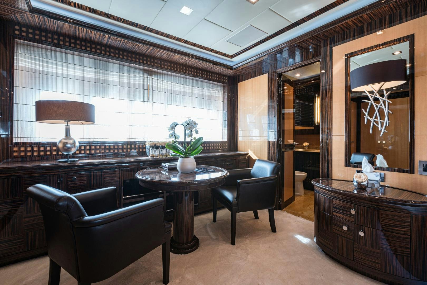 a room with a table and chairs aboard SERENITY Yacht for Sale