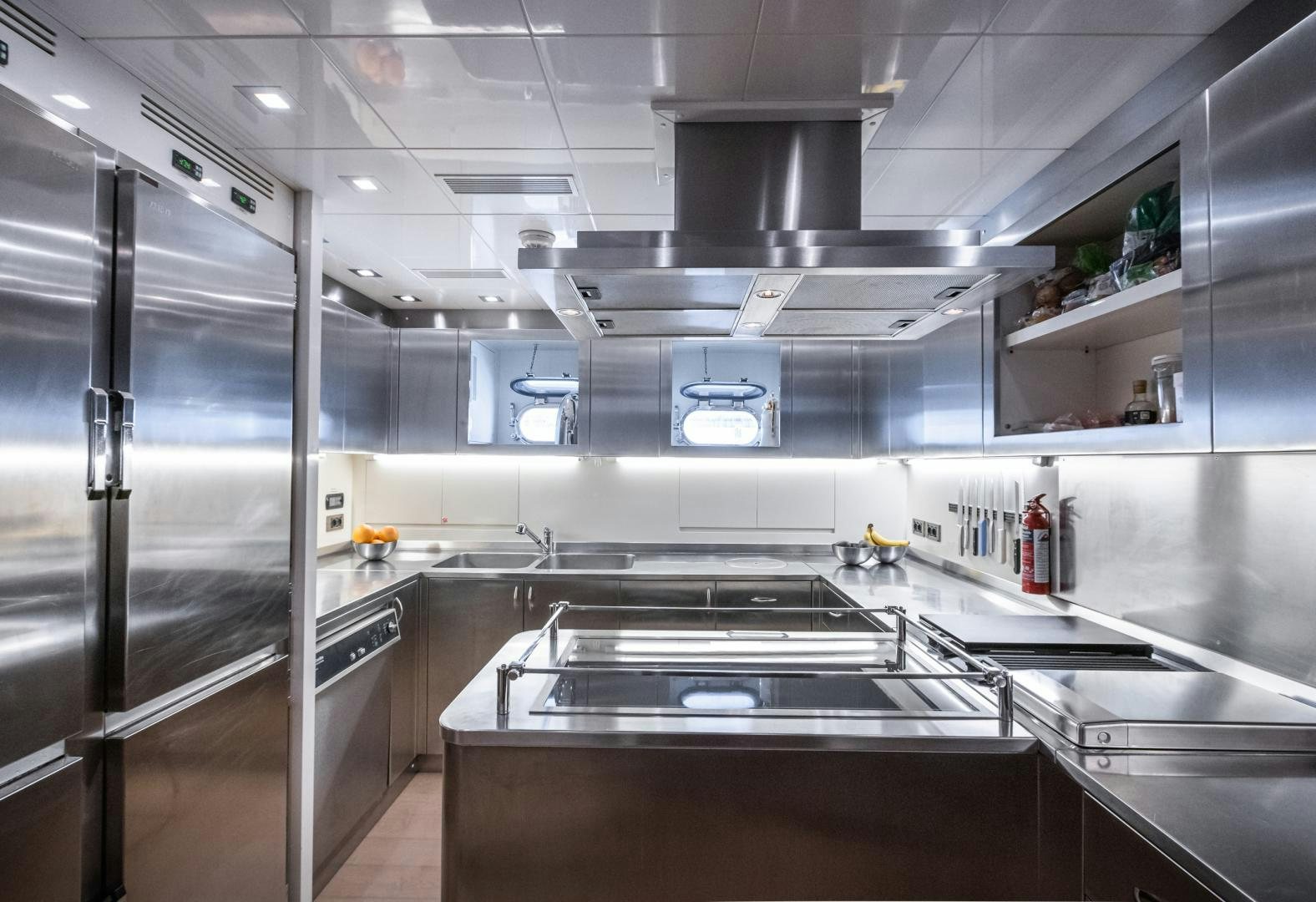 a large kitchen with stainless steel appliances aboard SERENITY Yacht for Sale